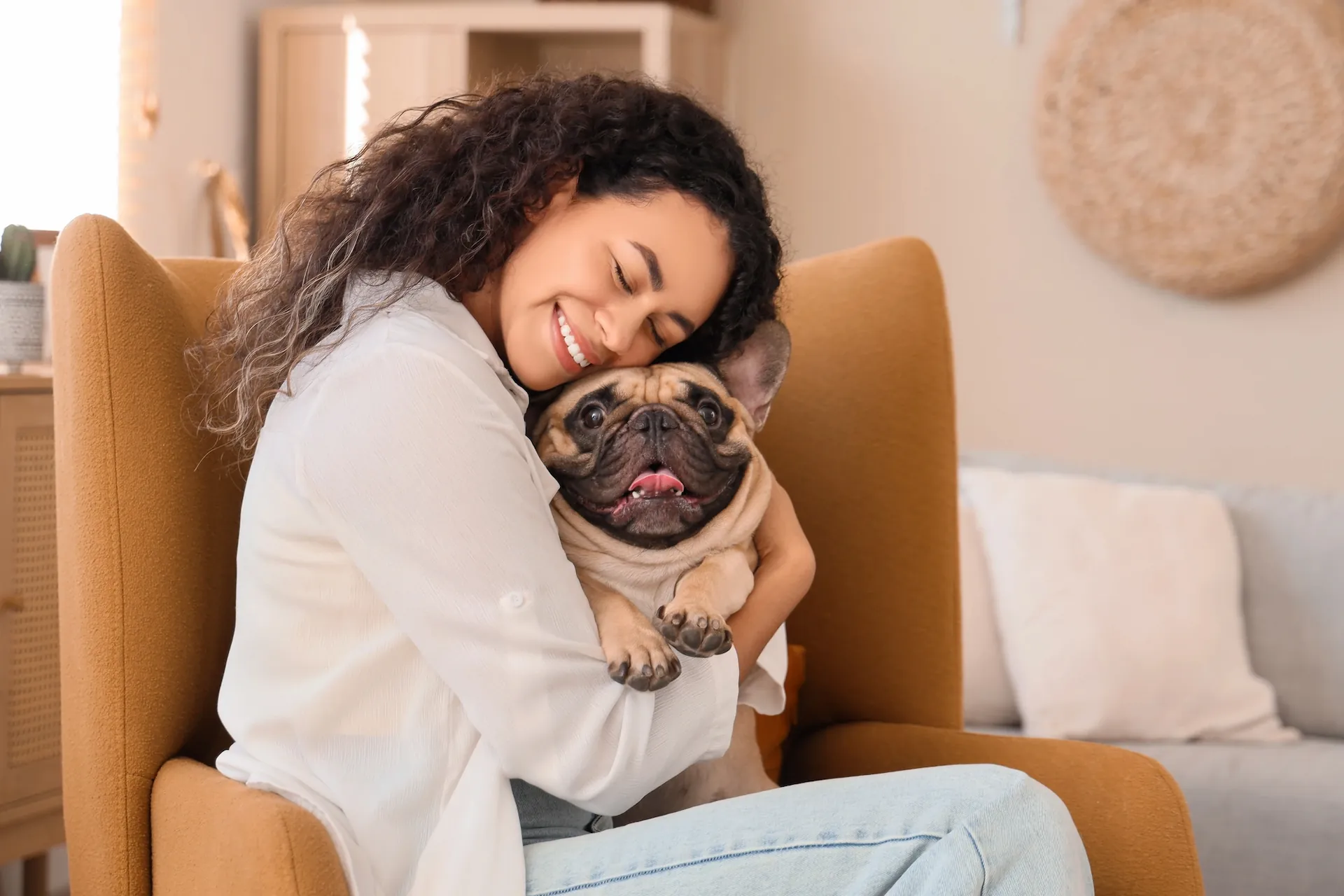 A woman holding a small dog.