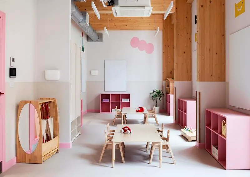 Interior photo of an Education project, with white space and warm tones in the structure