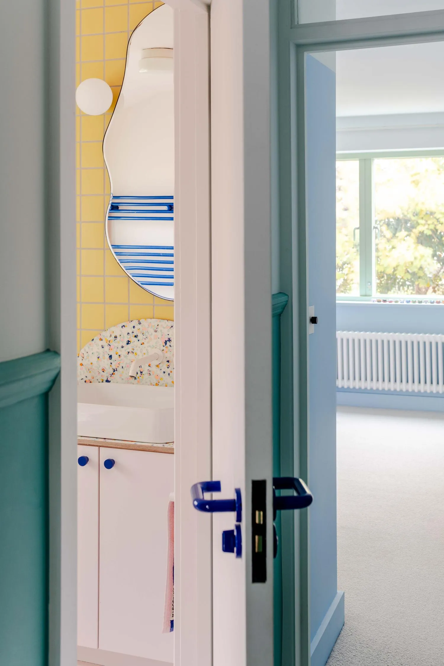 Photo showing a snippet into the bathroom with its colourful details and intricate shapes. By Office S&M, RIBA Chartered Architectural Practice in London.
