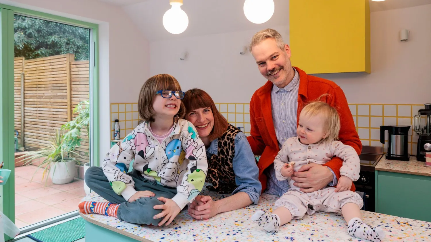 Photo of the client's family in the newly designed kitchen. By Office S&M, RIBA Chartered Architectural Practice in London.