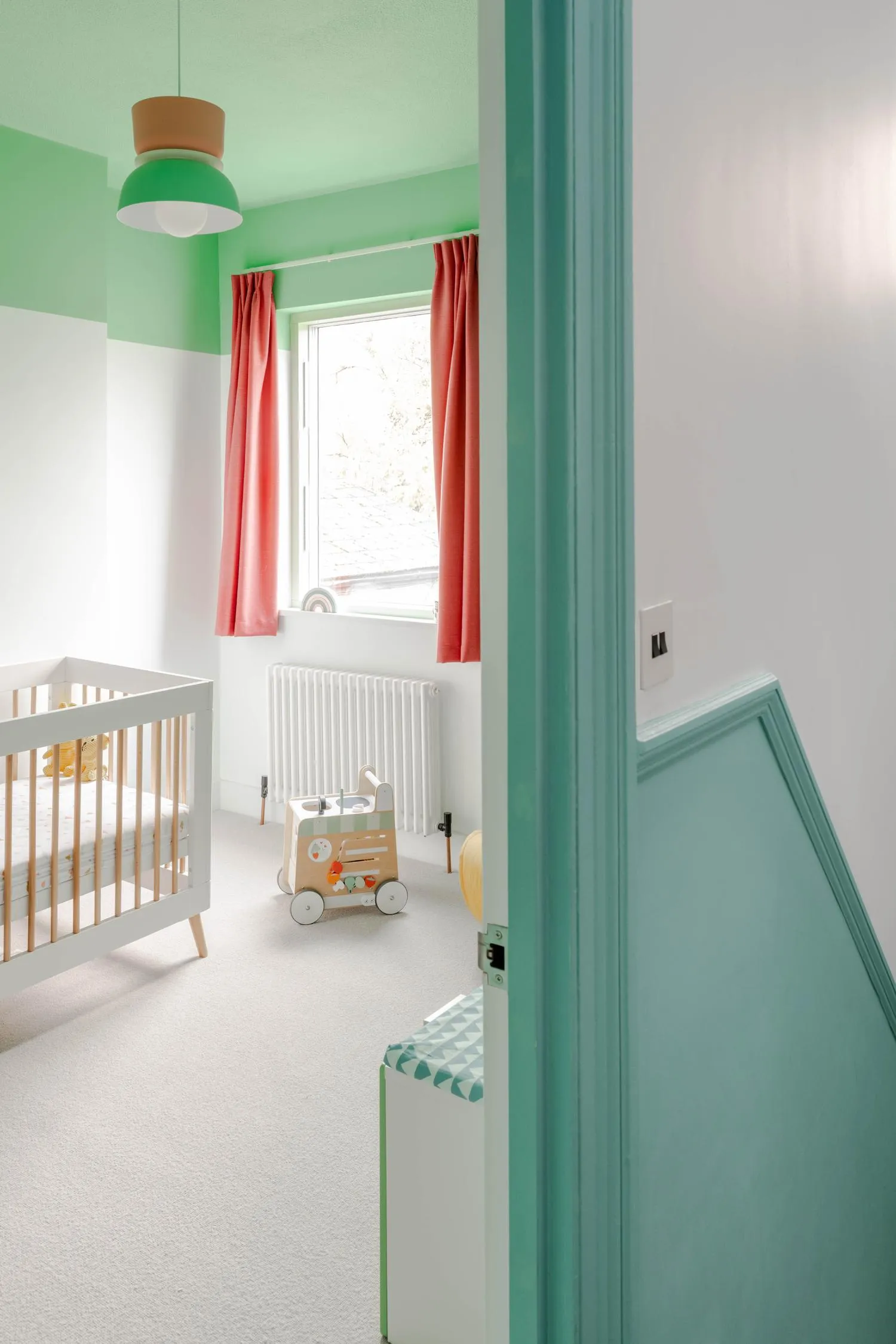 Photo of the children's room from the entrance, showing green and pastel hues of the spaces. By Office S&M, RIBA Chartered Architectural Practice in London.