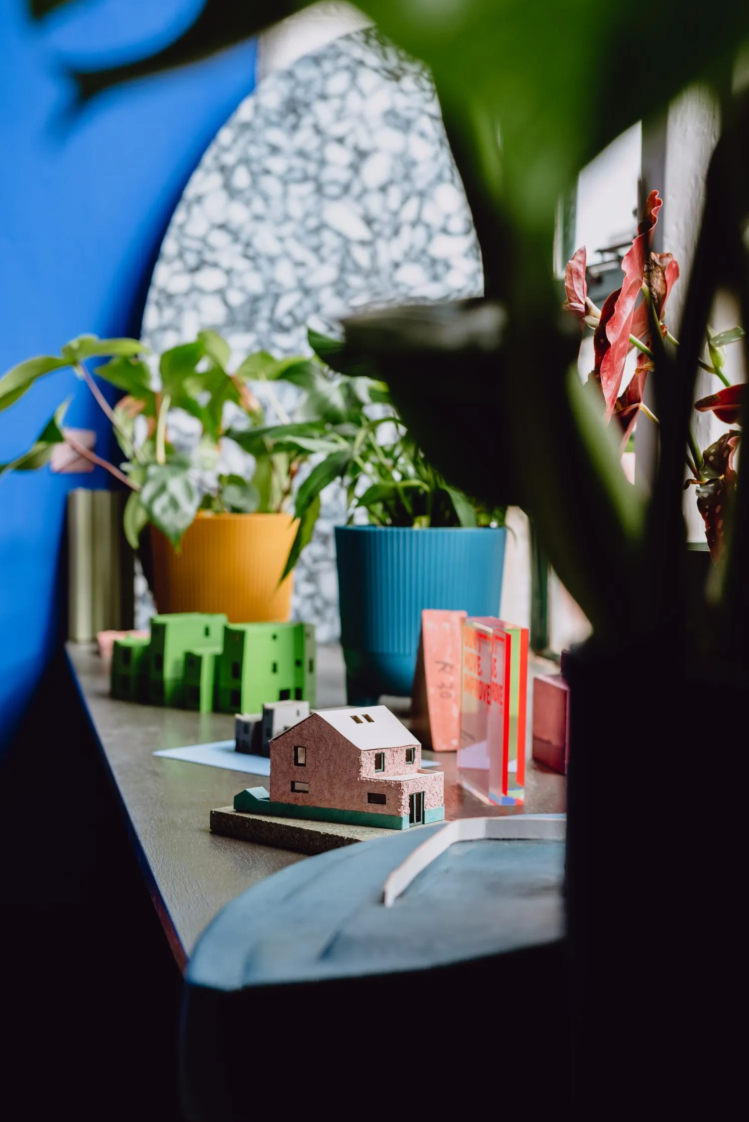 Photo of physical models of houses on a window parapet. By Office S&M, RIBA Chartered Architectural Practice in London.