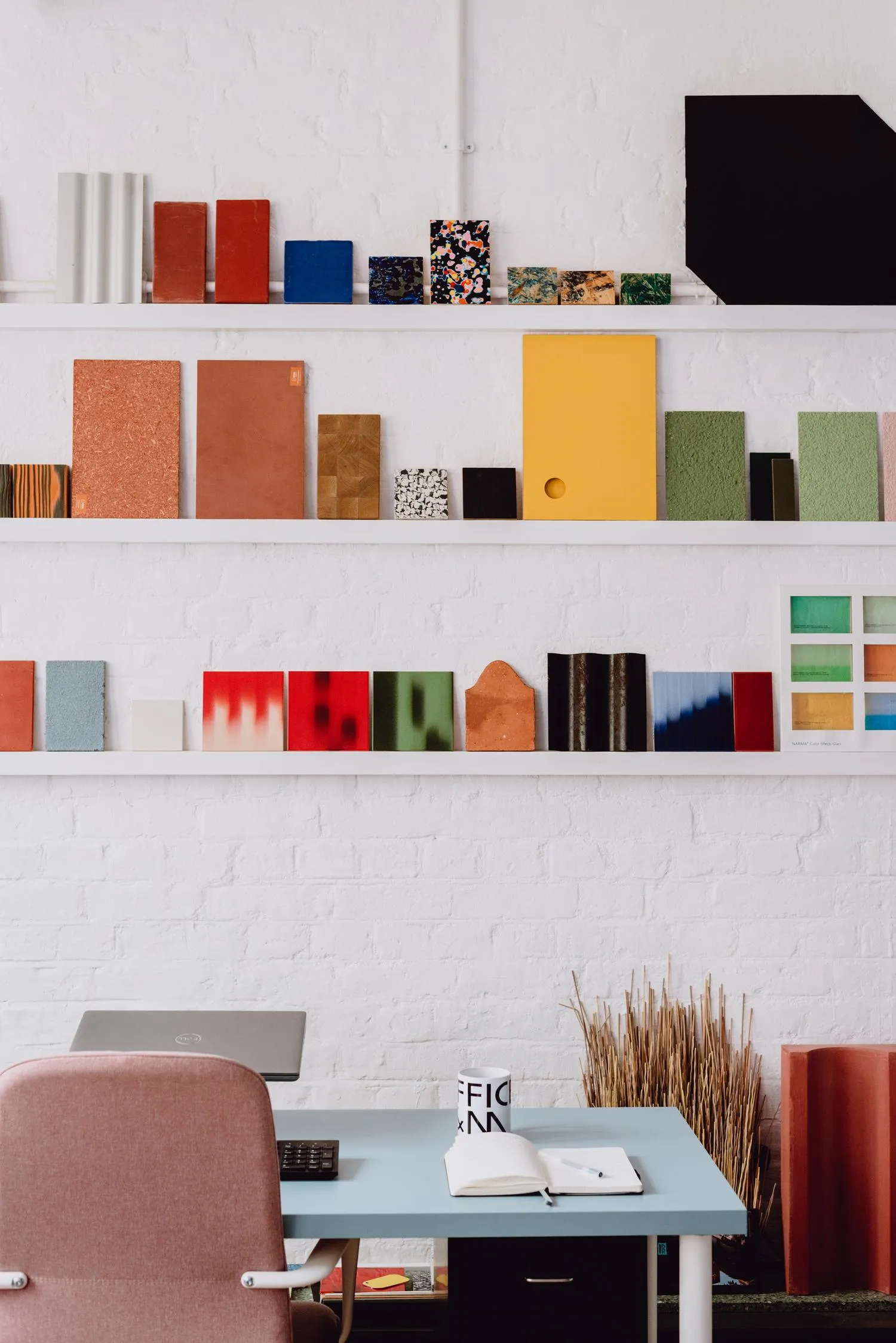 Zoomed in photo of the working space, focusing on the long shelving units with sample materials. By Office S&M, RIBA Chartered Architectural Practice in London.