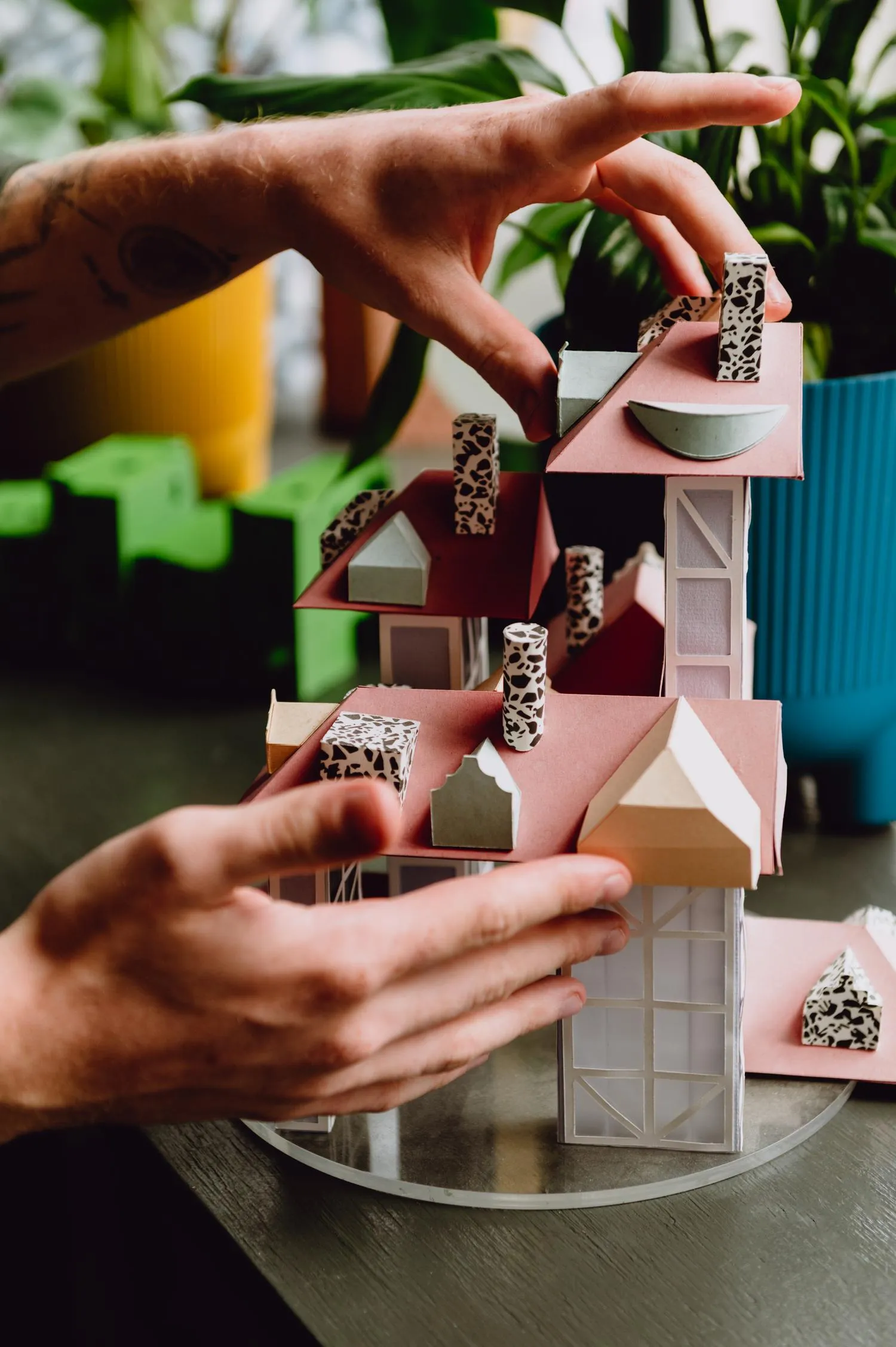 Zoomed in photo that focuses on the hands of the person showcasing a physical model of a house project. By Office S&M, RIBA Chartered Architectural Practice in London.