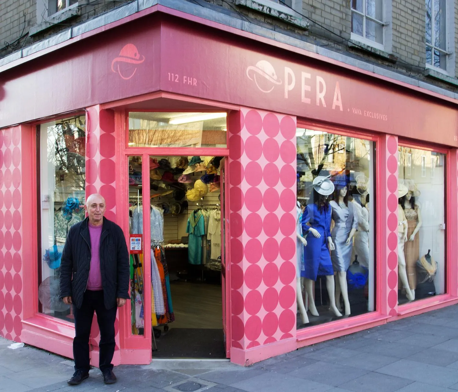 Owner of a corner fashion shop stood outside of the shop. By Office S&M, RIBA Chartered Architectural Practice in London.