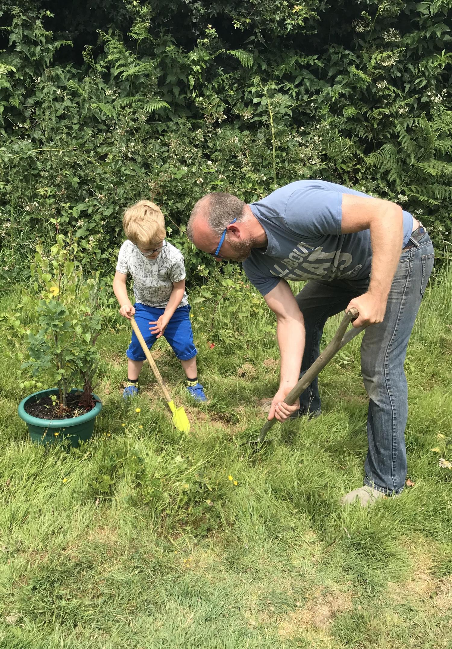 Photo of a man and a kid working in the garden or landscape. By Office S&M, RIBA Chartered Architectural Practice in London.