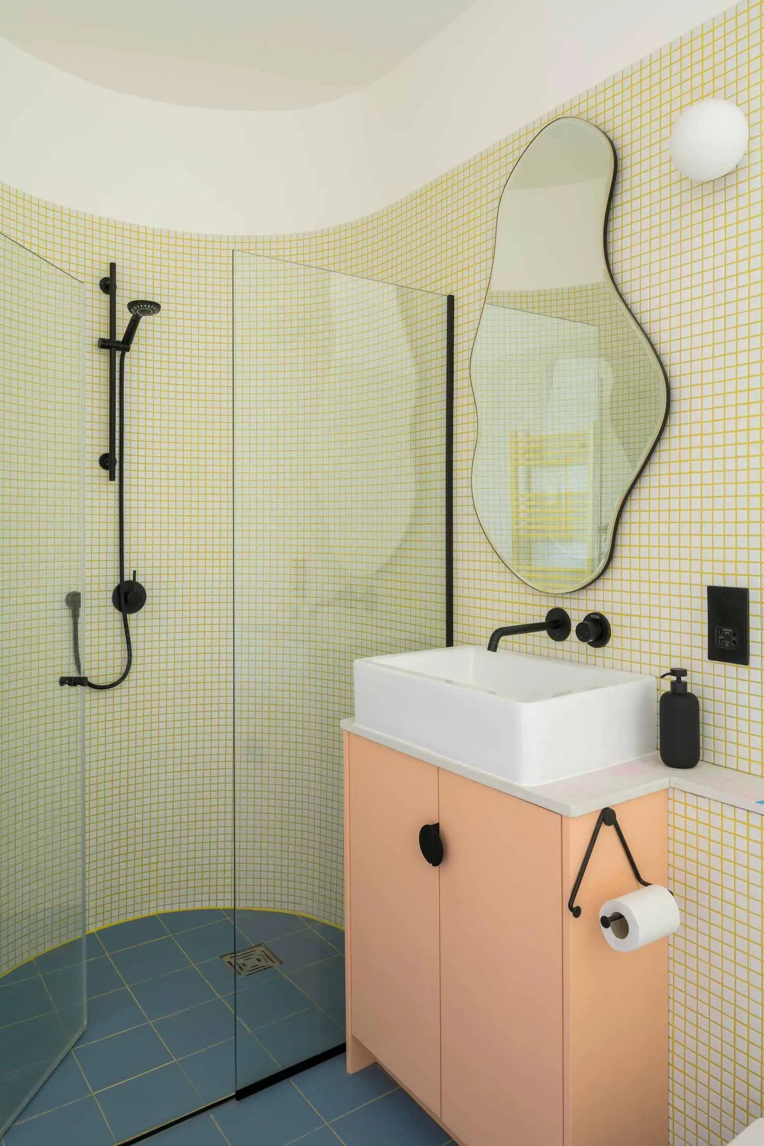 Photo of the shower room, with green tiles and peach cabinetry. By Office S&M, RIBA Chartered Architectural Practice in London.
