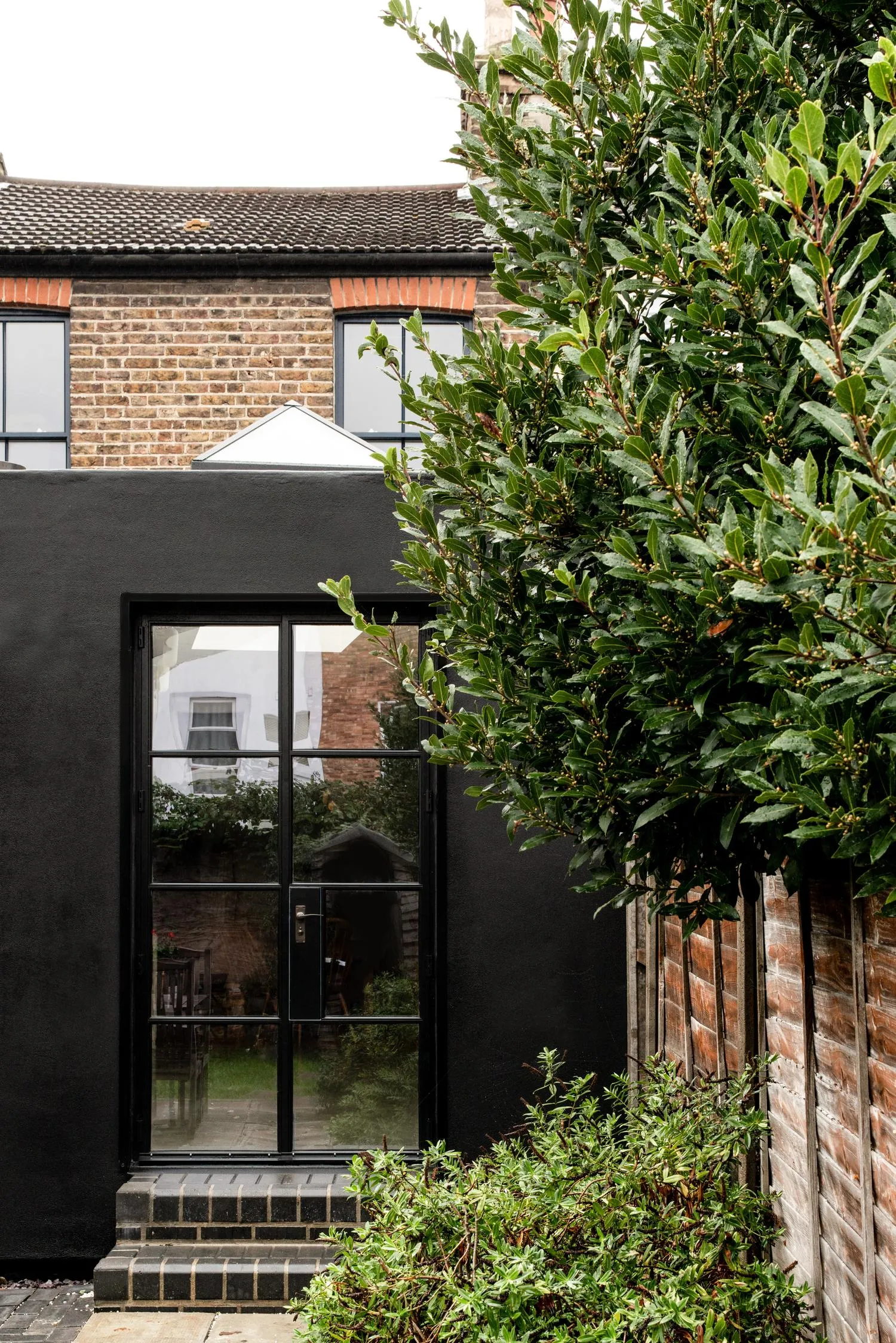 Photo of the rear kitchen doors from the garden. By Office S&M, RIBA Chartered Architectural Practice in London.