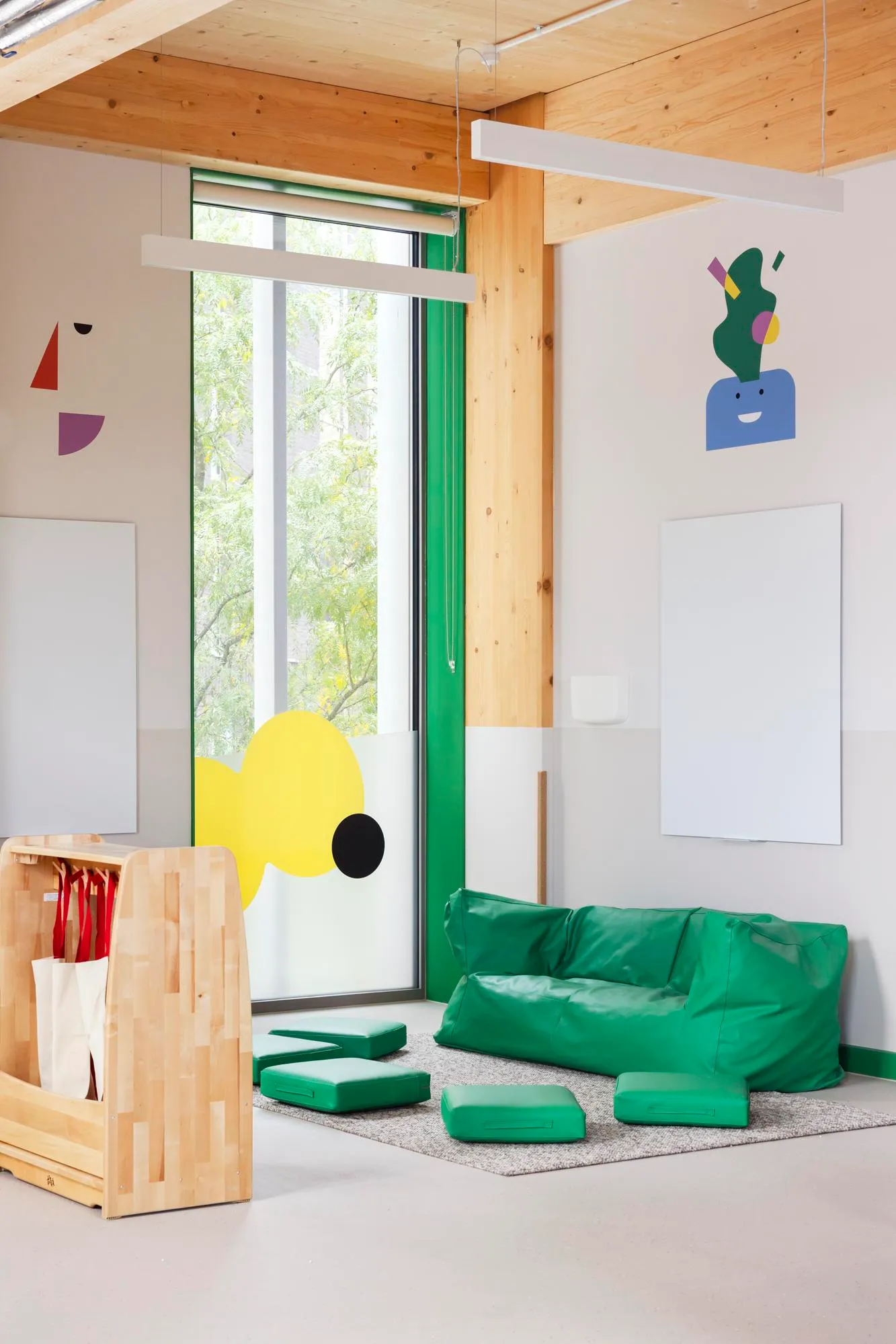 Photo of a breakout space with green accent and timber structure. By Office S&M, RIBA Chartered Architectural Practice in London.