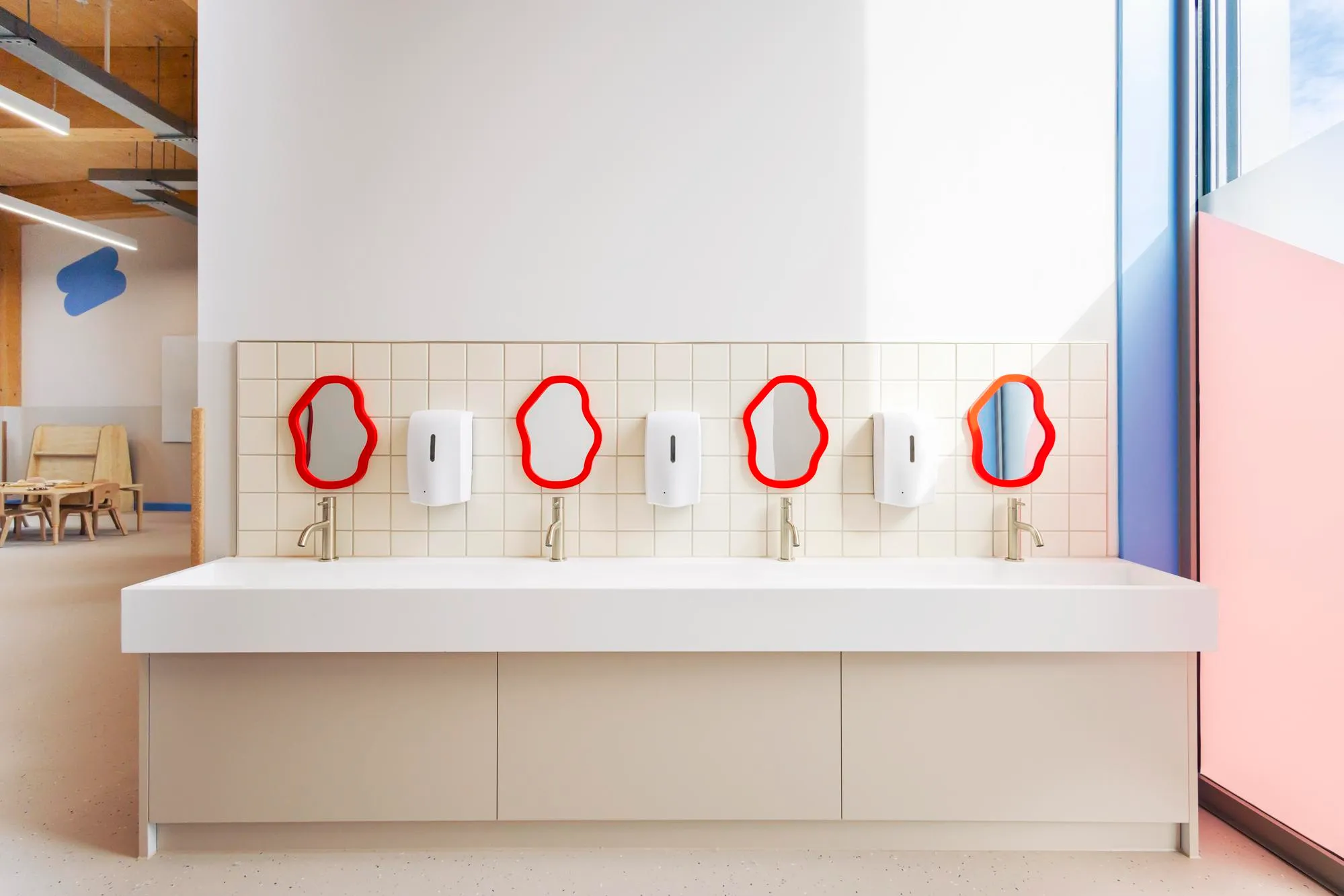 Photo of a long sink and playful mirrors above. By Office S&M, RIBA Chartered Architectural Practice in London.