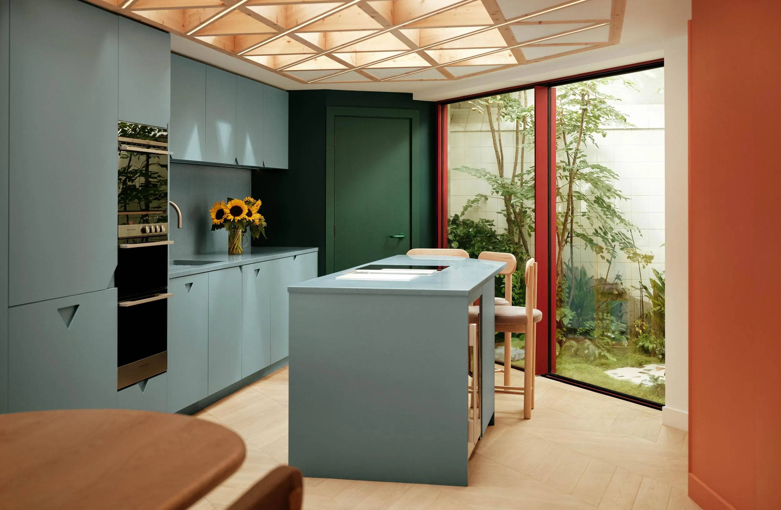 Photo of the kitchen space, with big window opening towards the garden. By Office S&M, RIBA Chartered Architectural Practice in London.