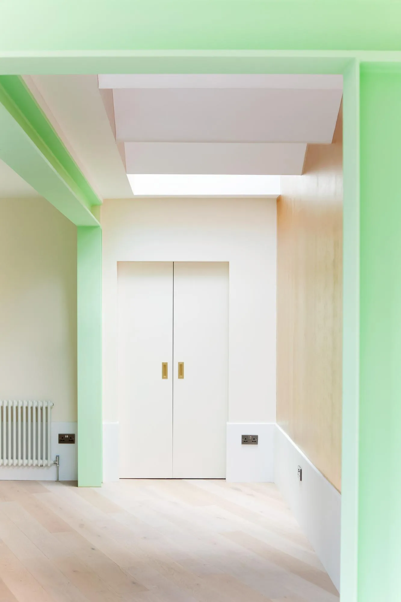 Photo of the internal space with green columns. By Office S&M, RIBA Chartered Architectural Practice in London.