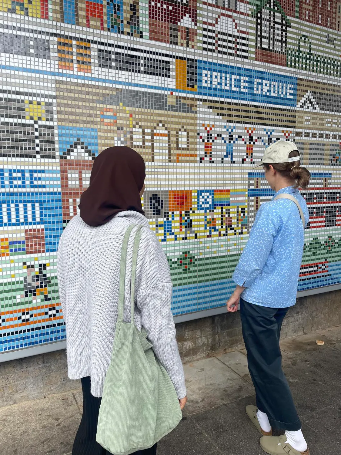 A couple of people admiring the mural. By Office S&M, RIBA Chartered Architectural Practice in London.