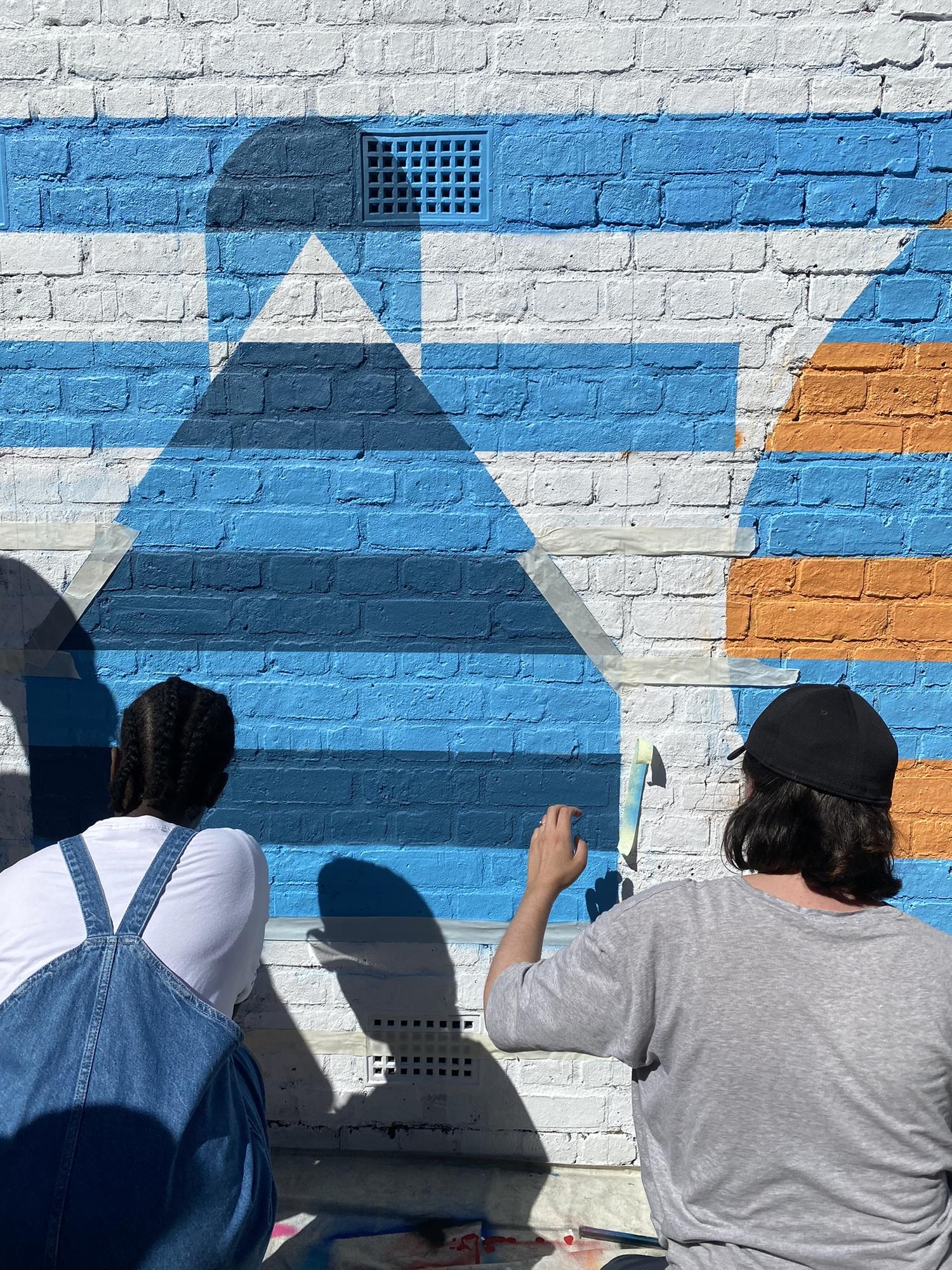 A young person and a professional painter working on a mural. By Office S&M, RIBA Chartered Architectural Practice in London.