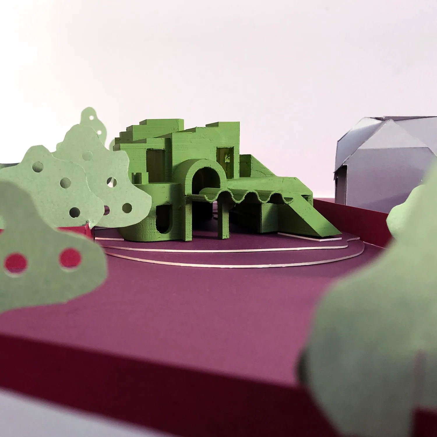 Photo of a physical, green model, showing the proposal from rear left side. By Office S&M, RIBA Chartered Architectural Practice in London.