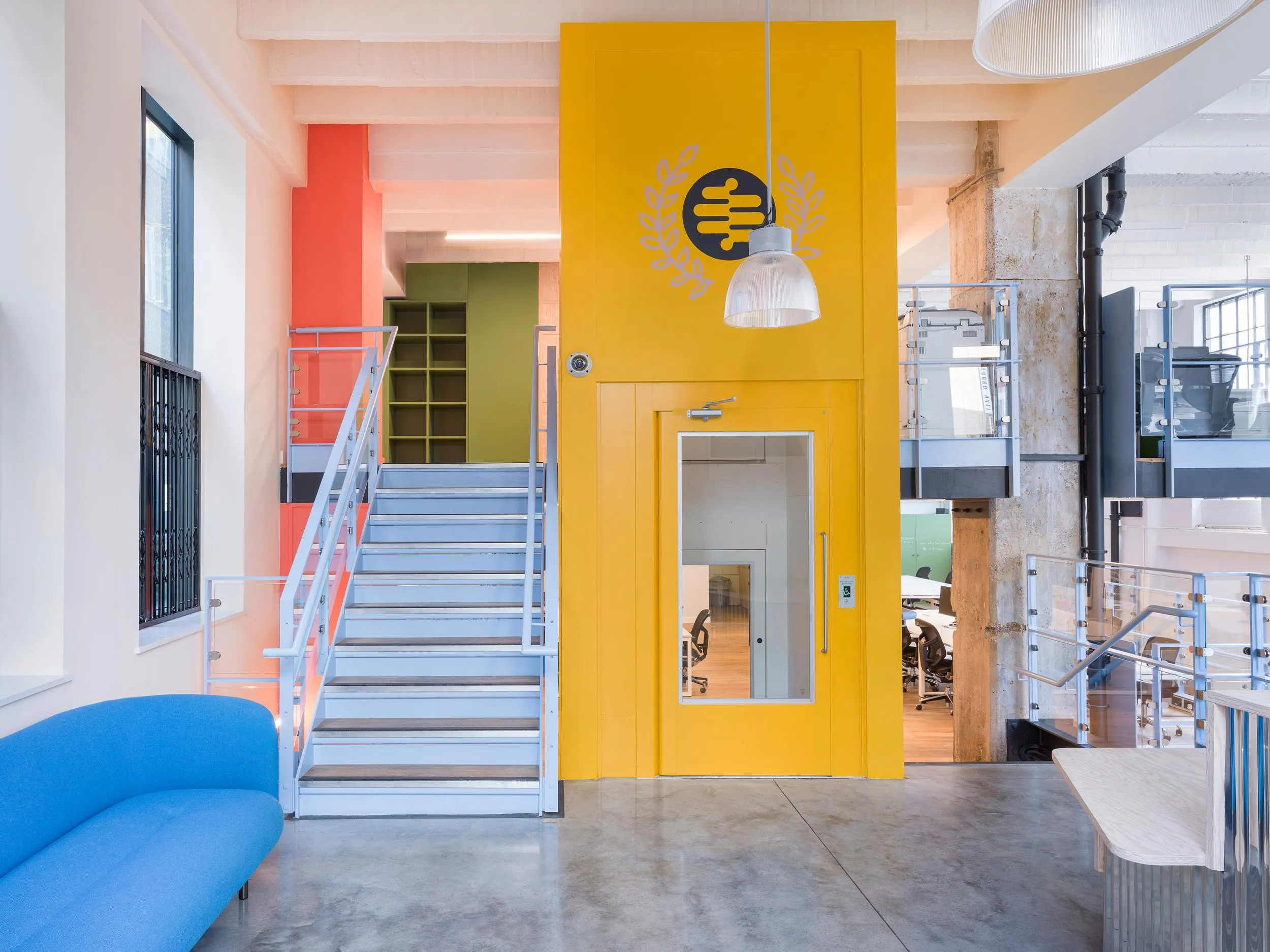 Overview photo of the reception area, with a lift and staircase in the background. By Office S&M, RIBA Chartered Architectural Practice in London.