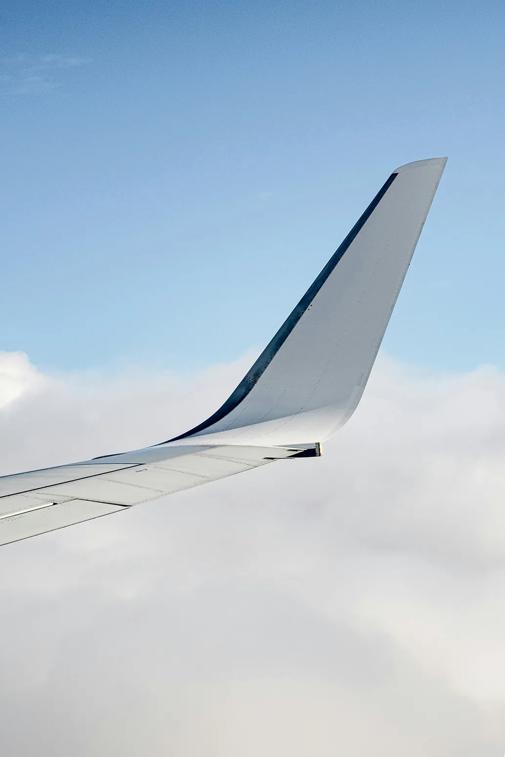 Plane wing above the cloud