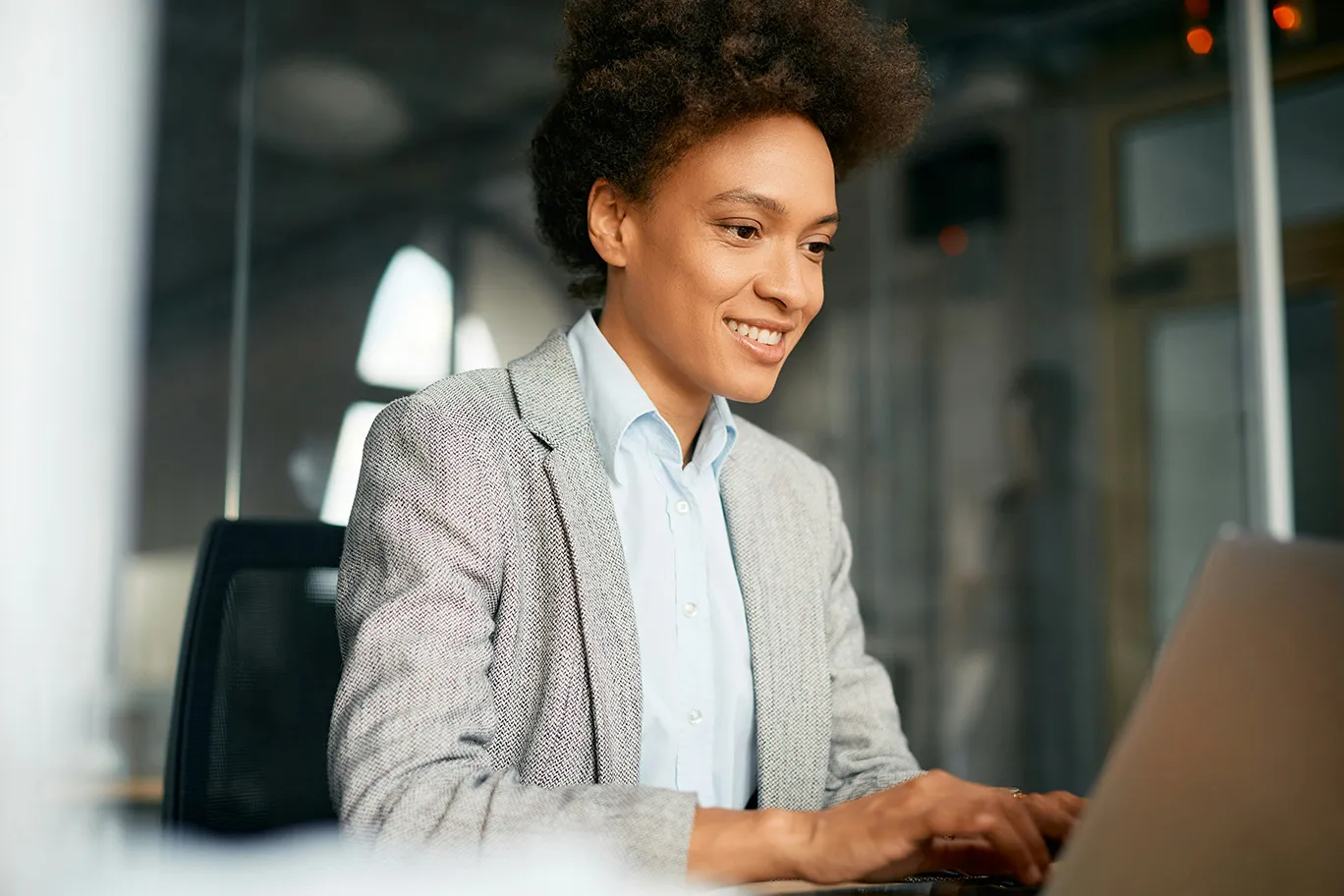 Women in suit working on her laptop