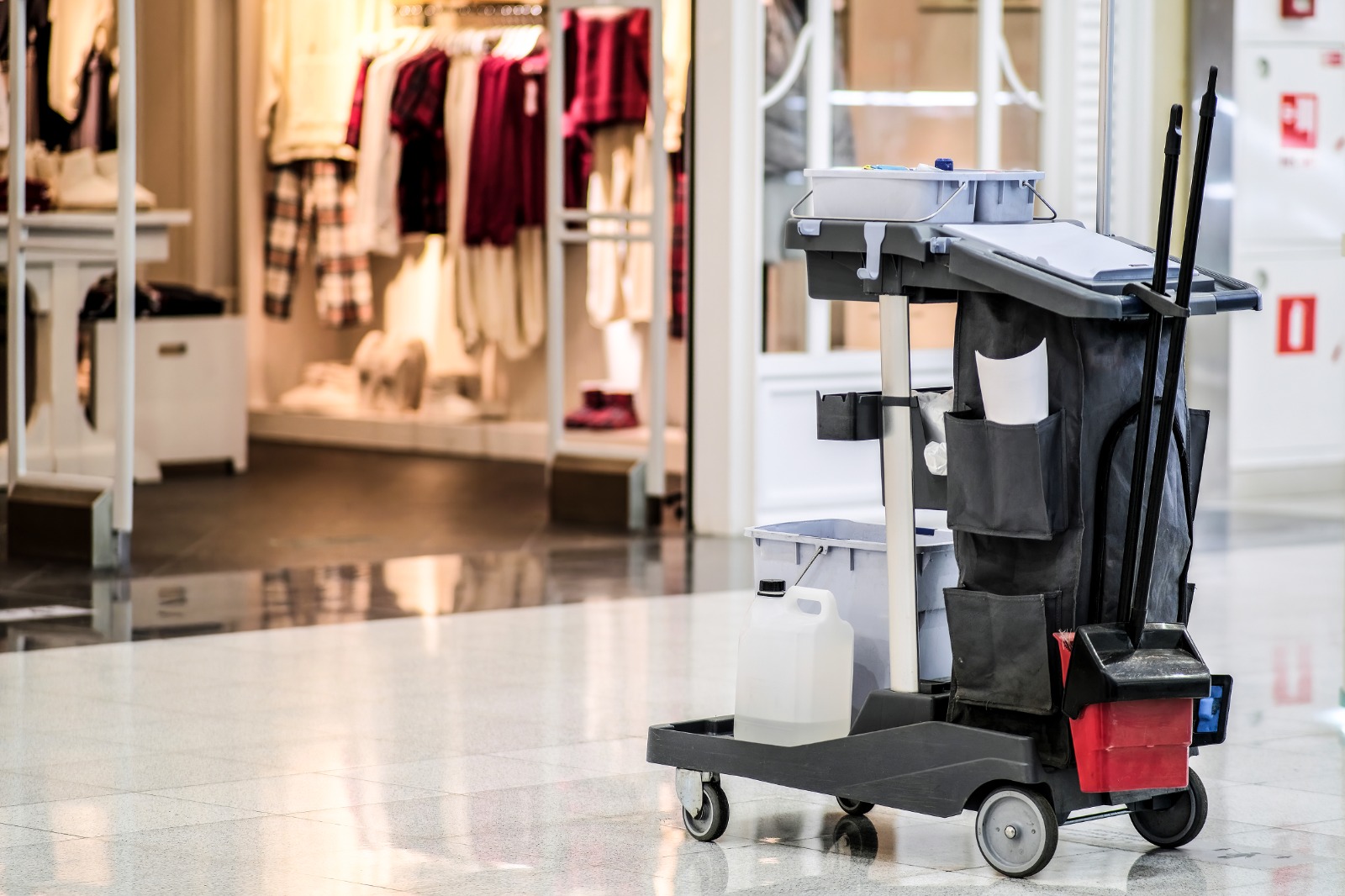 Person cleaning the shops outside