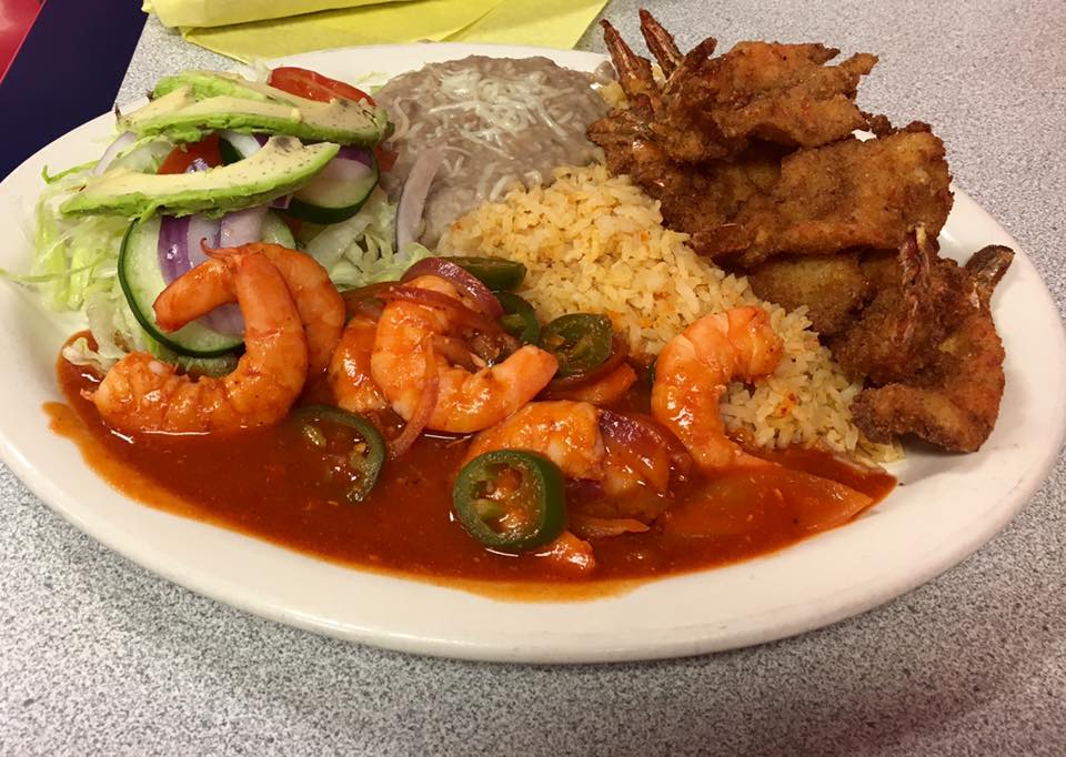A plate of food with shrimp, rice, and vegetables.