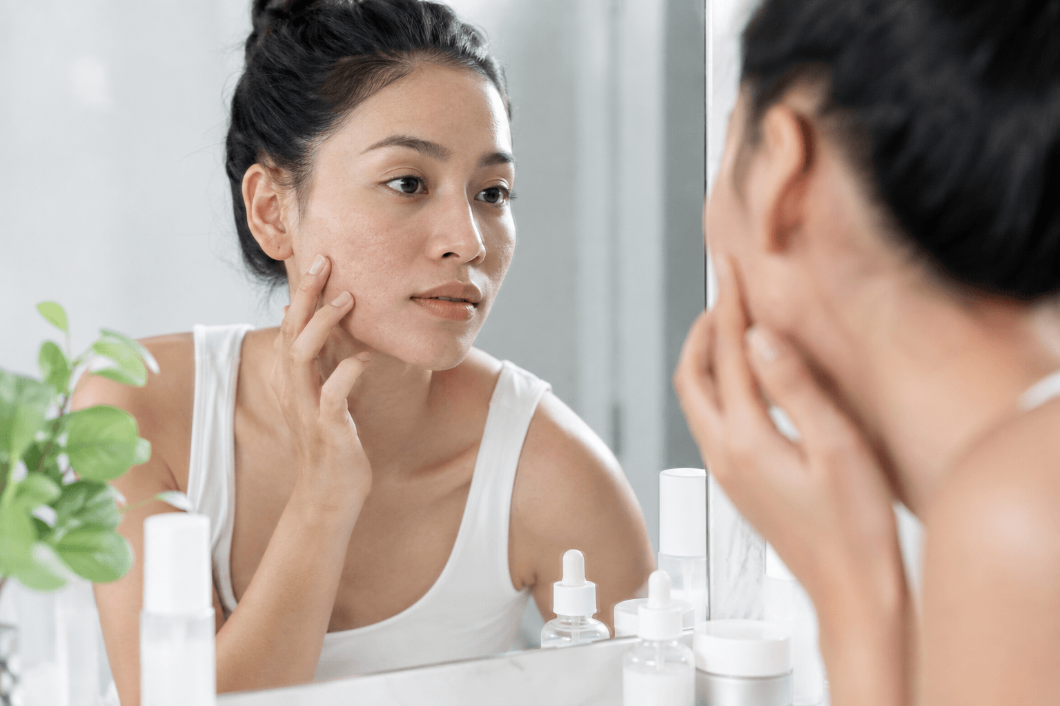 Provider performing a microneedling treatment for acne scars on a client's cheek in Denver