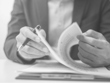 contract litigation person sittign at desk leafing through a stack of papers