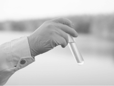 civil litigation a scientist arm with rubber glove on holding a test tube