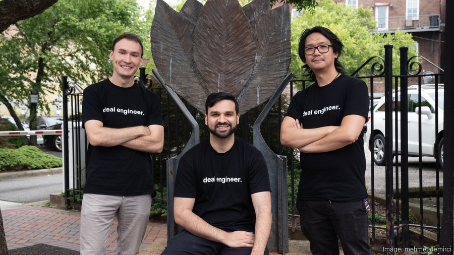 Opine founders together near sculptural wings outdoors