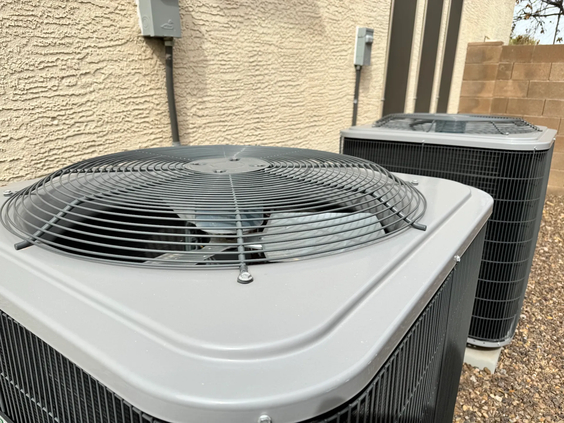 two condenser units on side of house