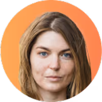 Portrait of a woman with long light brown hair and blue eyes against an orange background.