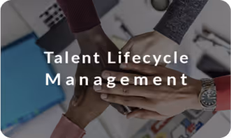 Diverse group of people stacking hands together over a desk with the text 'Talent Lifecycle Management'.