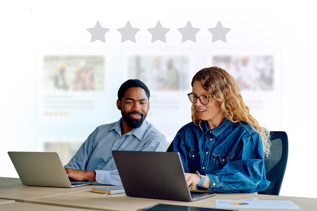 Two colleagues working on laptops beneath a five-star course rating