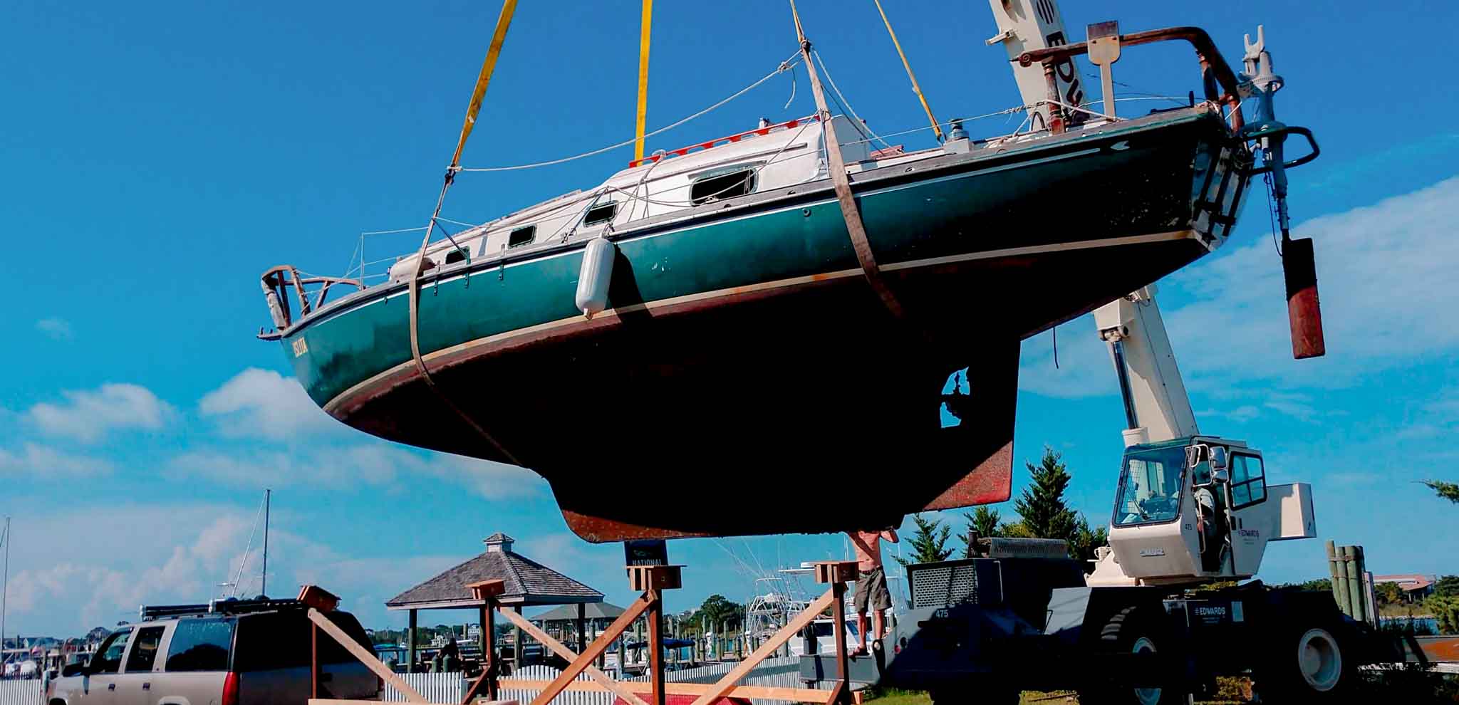 Sailboat being lifted during a documented project milestone for a client. Ocracoke Island