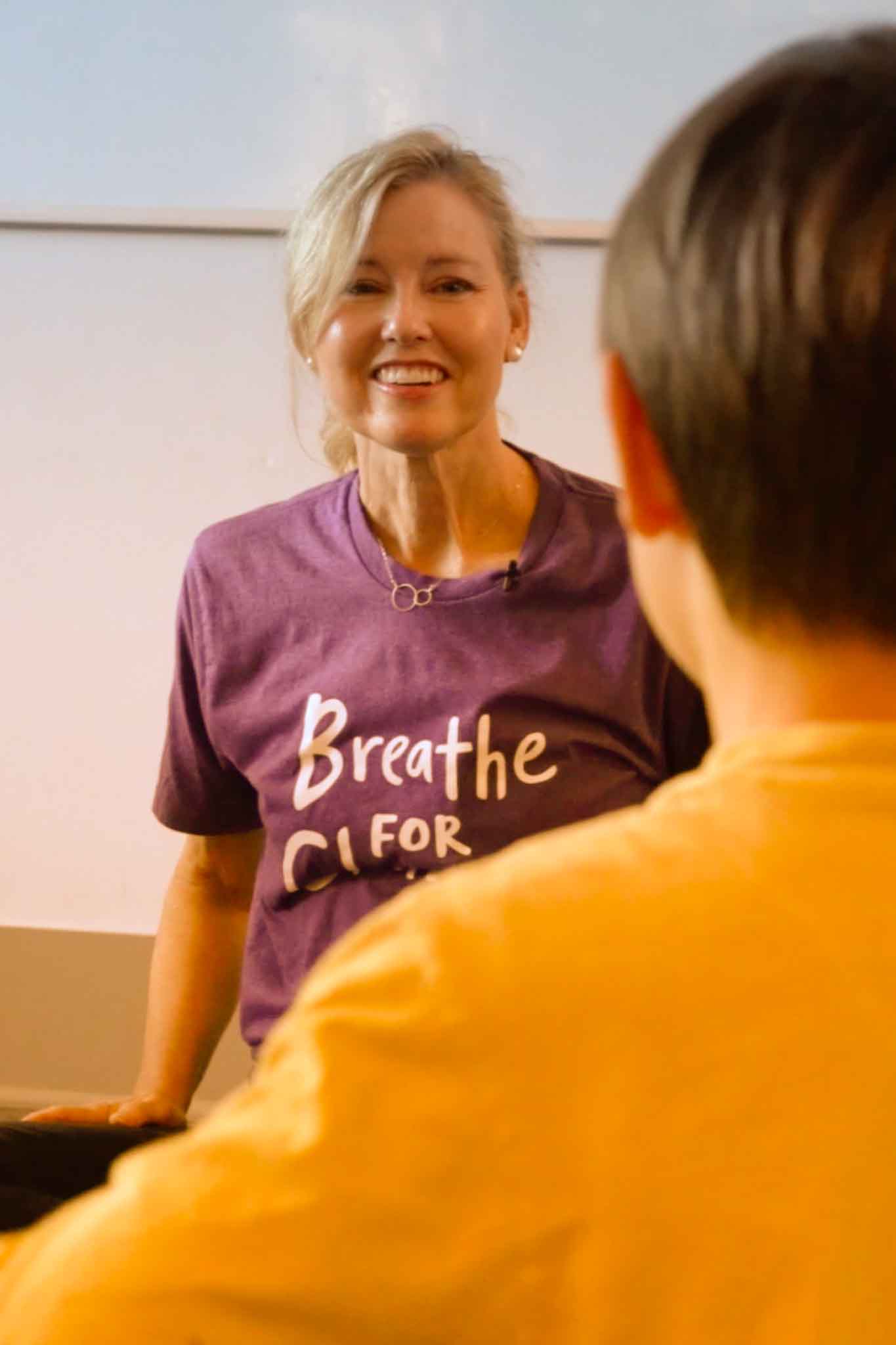 Teacher speaking to kid on camera during a school video production shoot.
