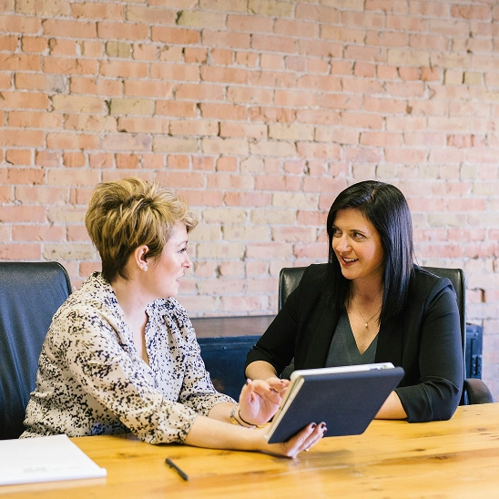 Two women discussing business
