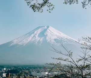 Clear view of Mount Fuji with blue sky and surrounding town.