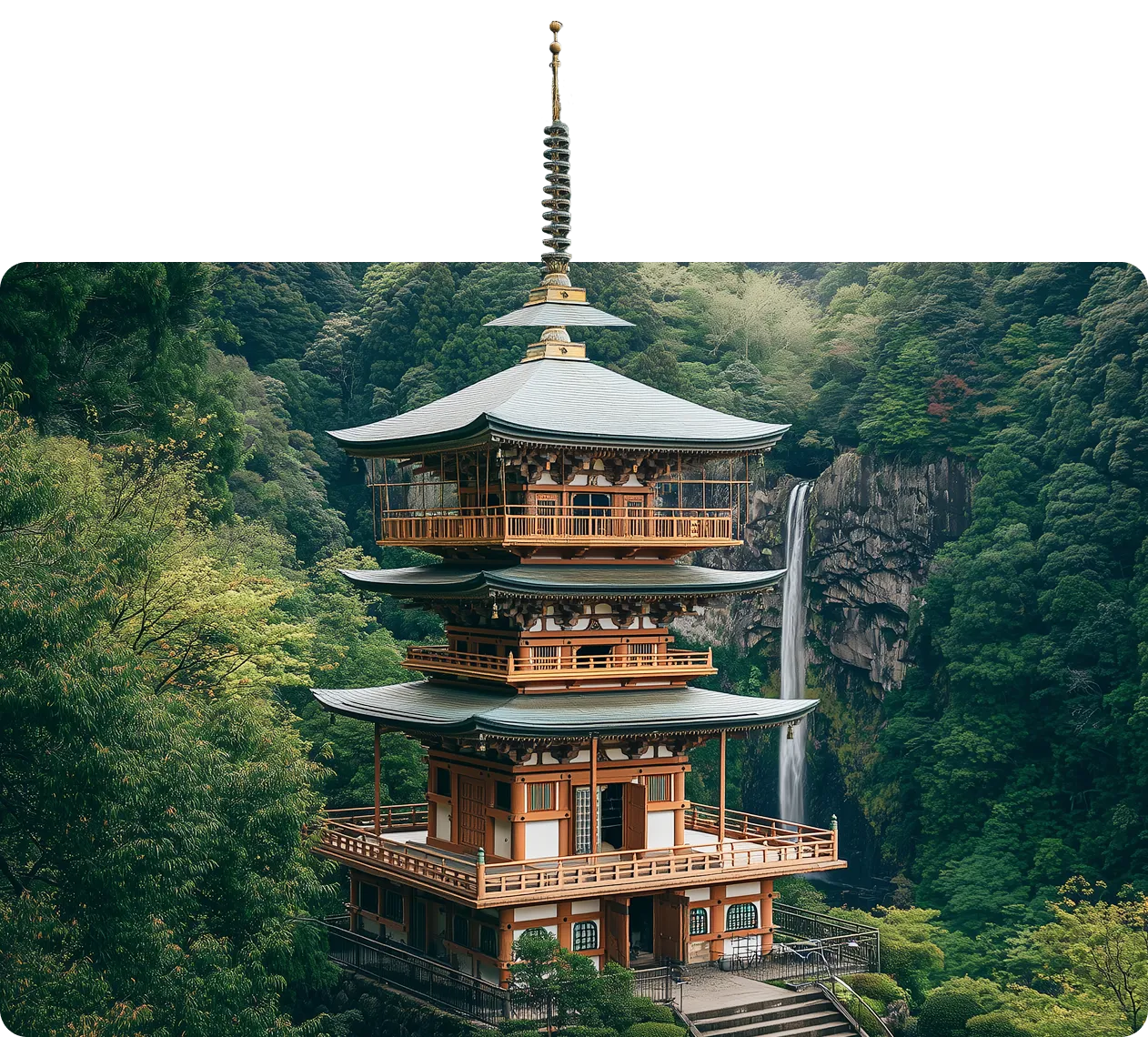 Pagoda surrounded by dense green forest with a waterfall behind it