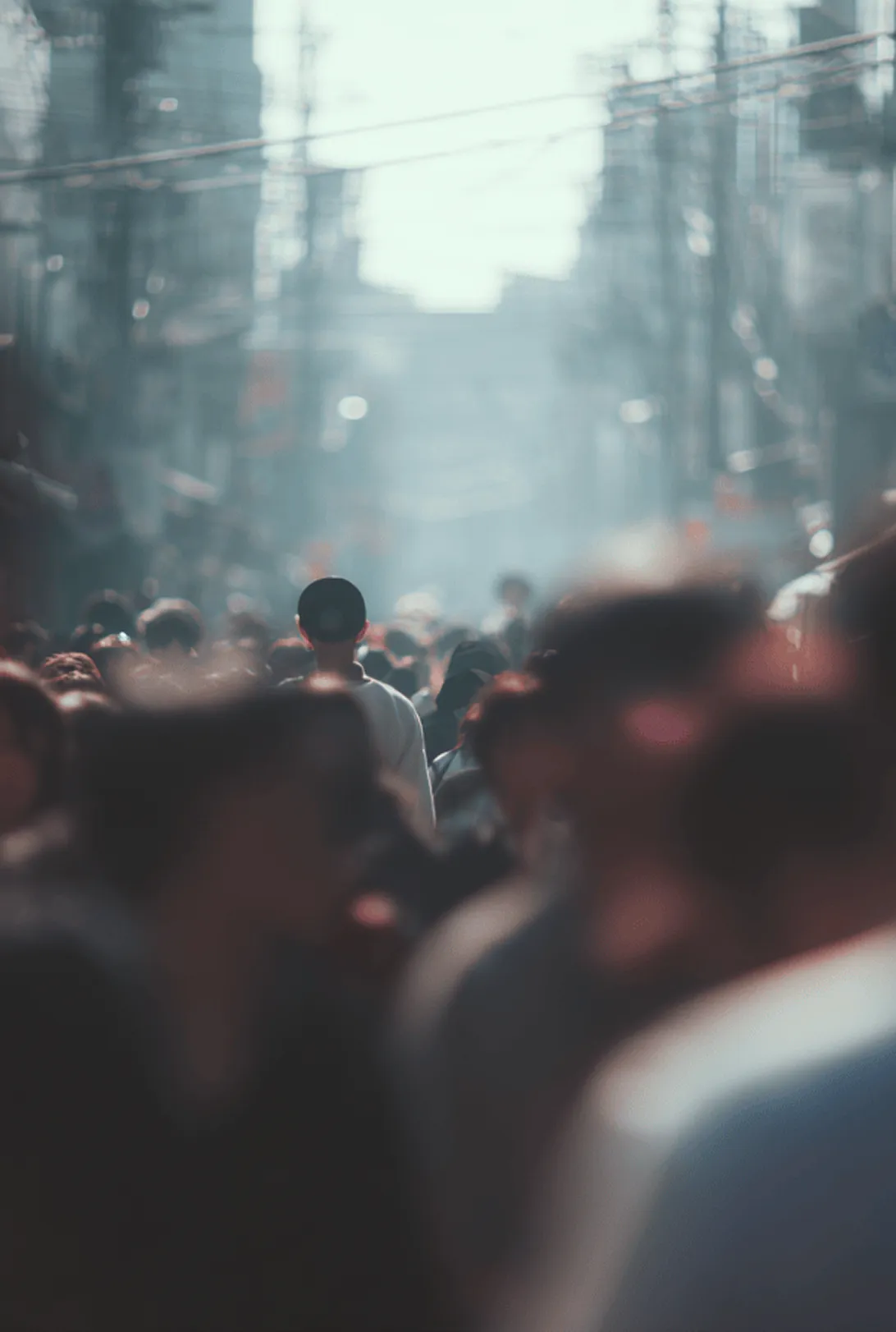 Crowded street with a person visible at the center through the blur