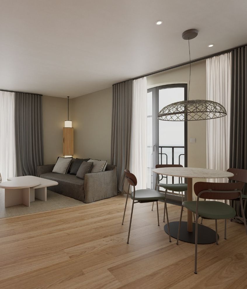 Coin salon avec canapé et table dans la Suite Duplex Familiale du Grand Hôtel de Courtoisville à Saint-Malo.