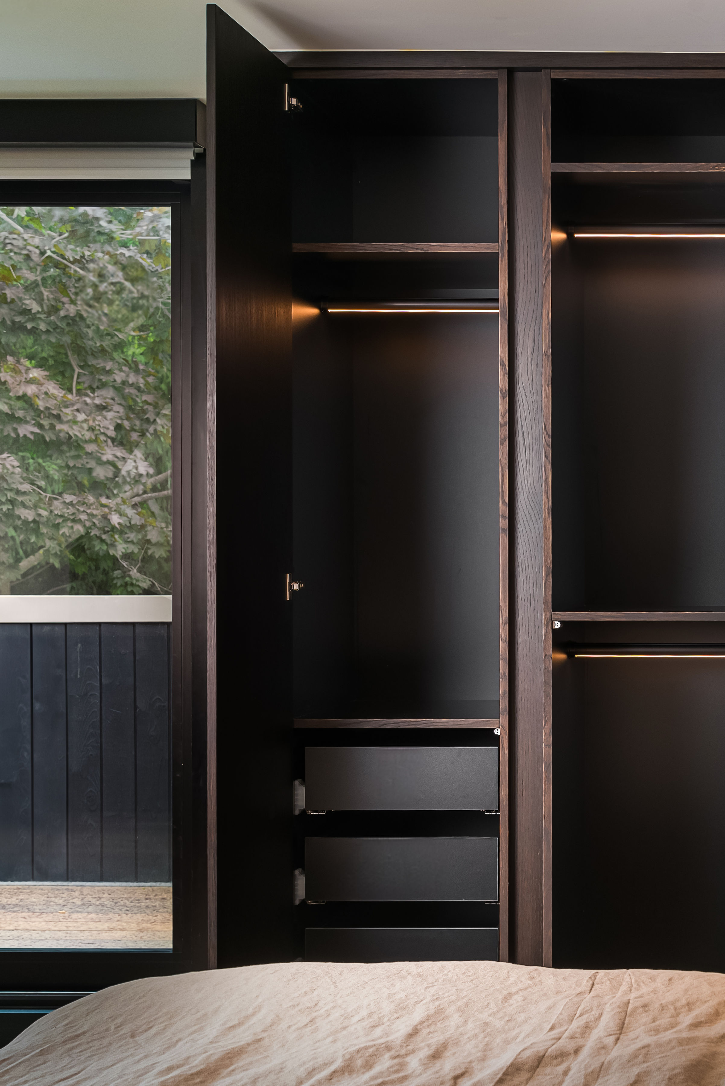 Different perspective of modern bedroom shelving and storage by Goosen Inc.