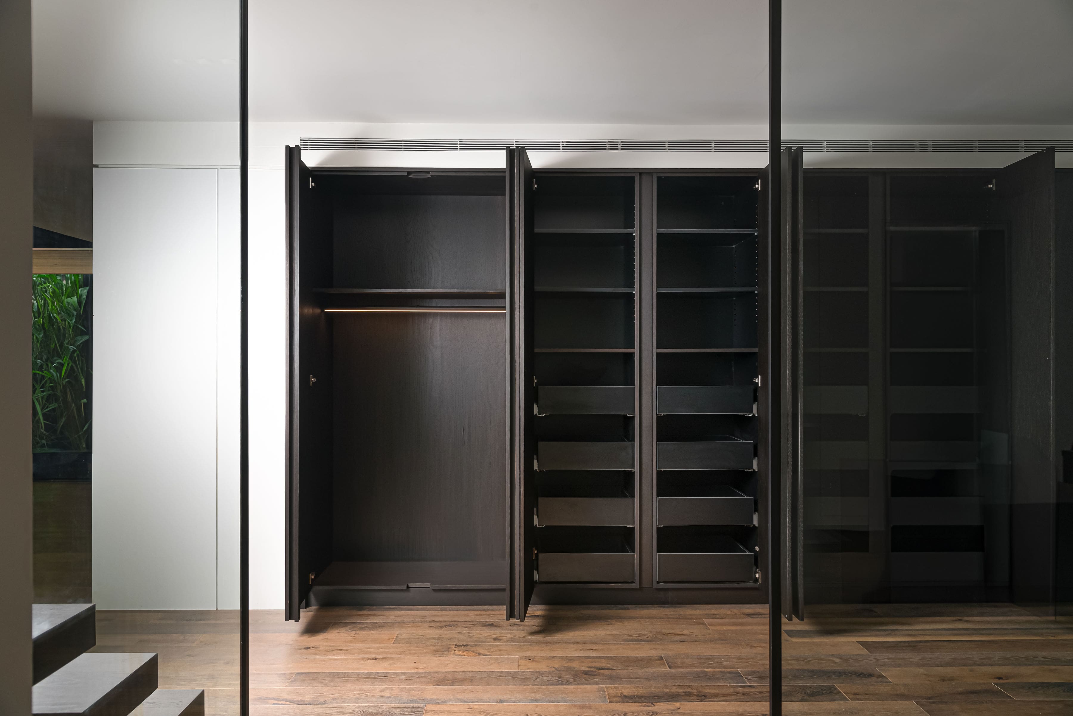 Custom cabinetry closets with modern millwork in a private Richmond Hill residence by Goosen Inc.