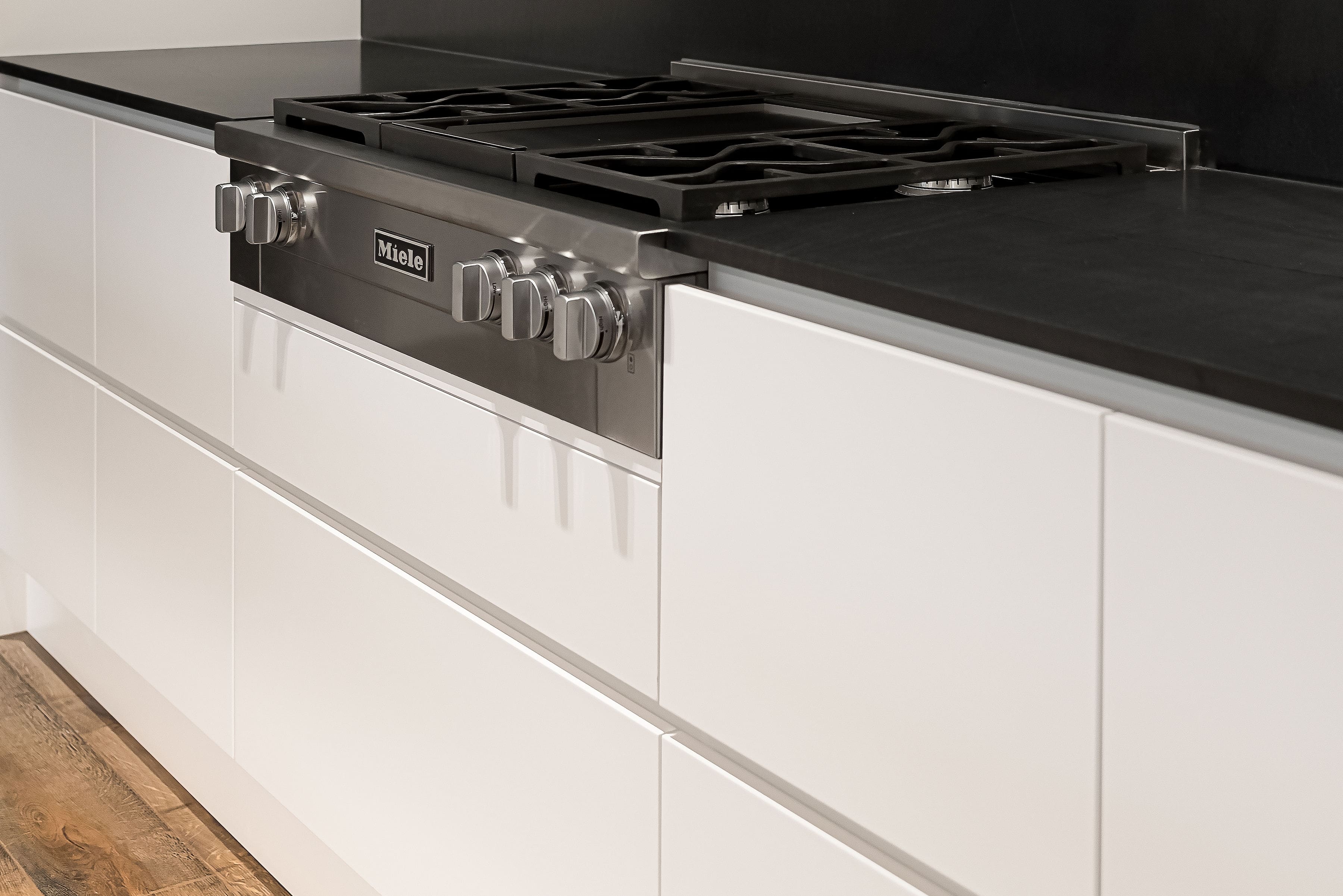 Modern stove with surrounding custom cabinetry in a private Richmond Hill residence by Goosen Inc.