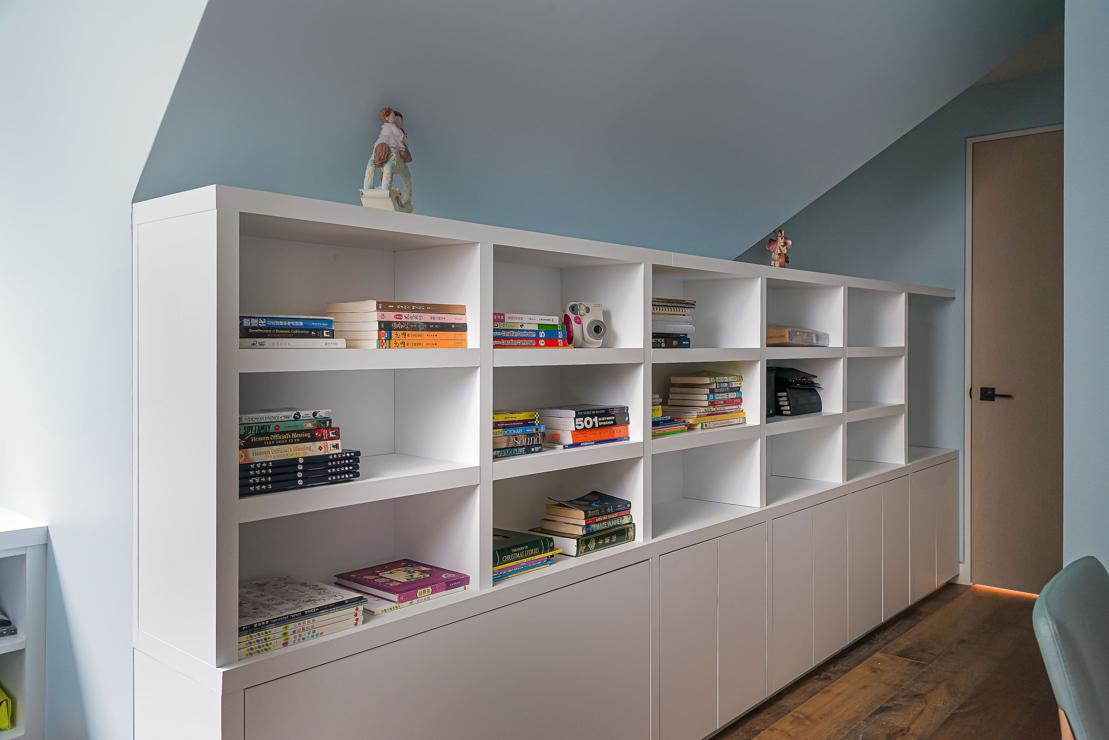 Custom bookshelf with integrated cabinetry in a private Richmond Hill residence by Goosen Inc.
