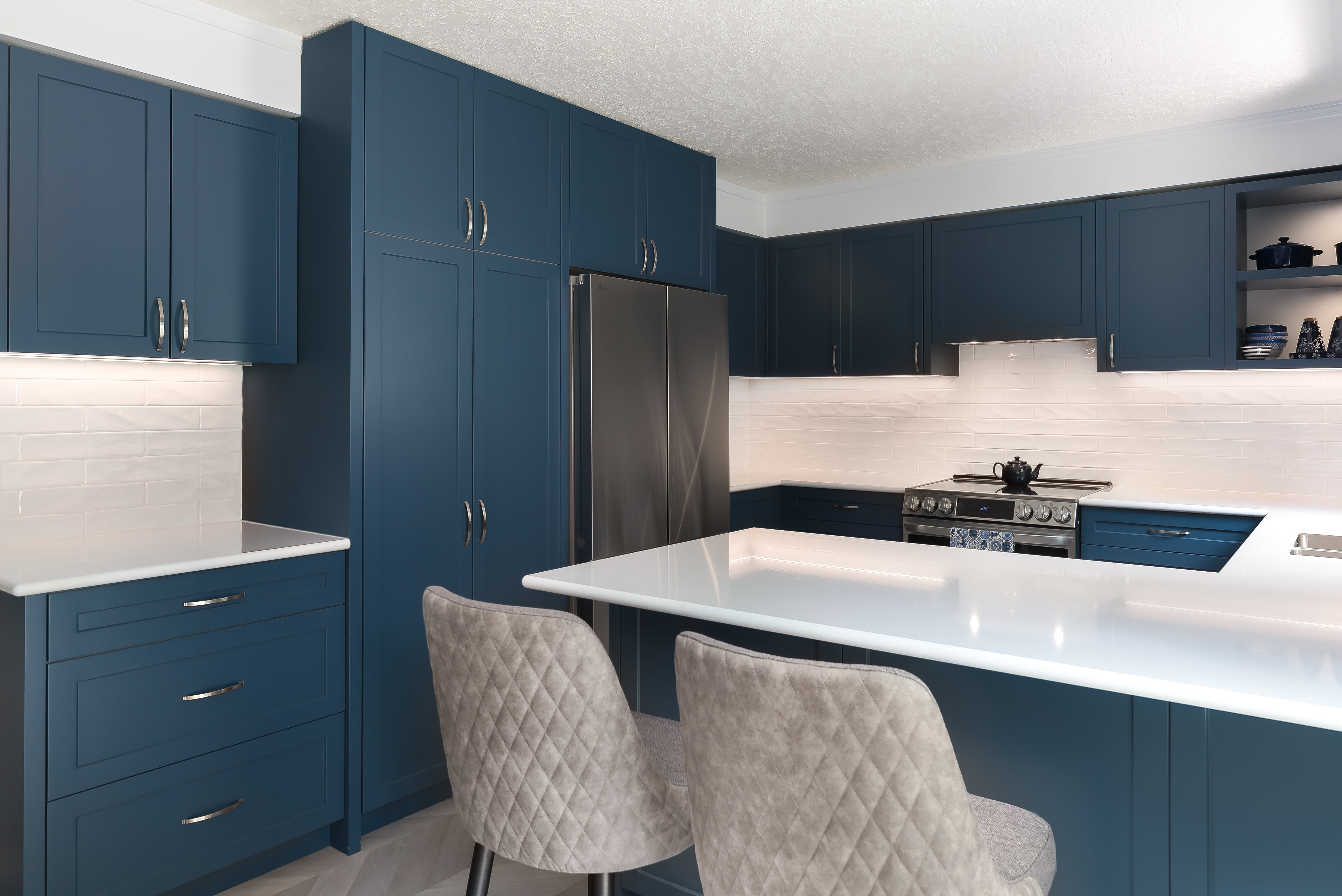 Wide view of a custom kitchen by Goosen Inc. in Kitchener, Ontario, highlighting elegant cabinetry, architectural millwork, and a spacious countertop in a newly renovated home.