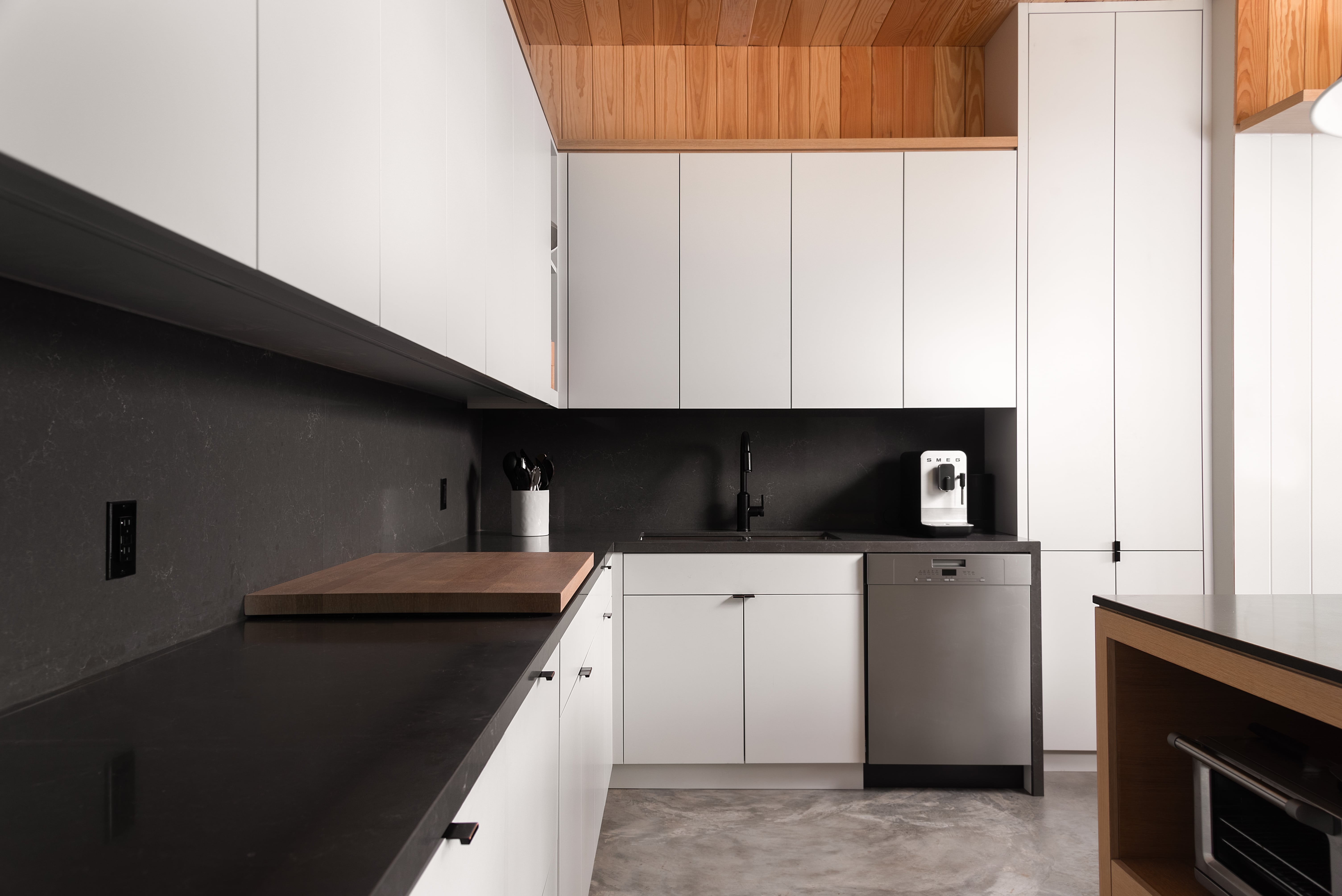 Custom kitchenette millwork and cabinetry by Goosen Inc. in the Acton Boathouse on Muskoka Lake, Ontario, featuring premium woodwork, modern design, and functional storage solutions for waterfront living.
