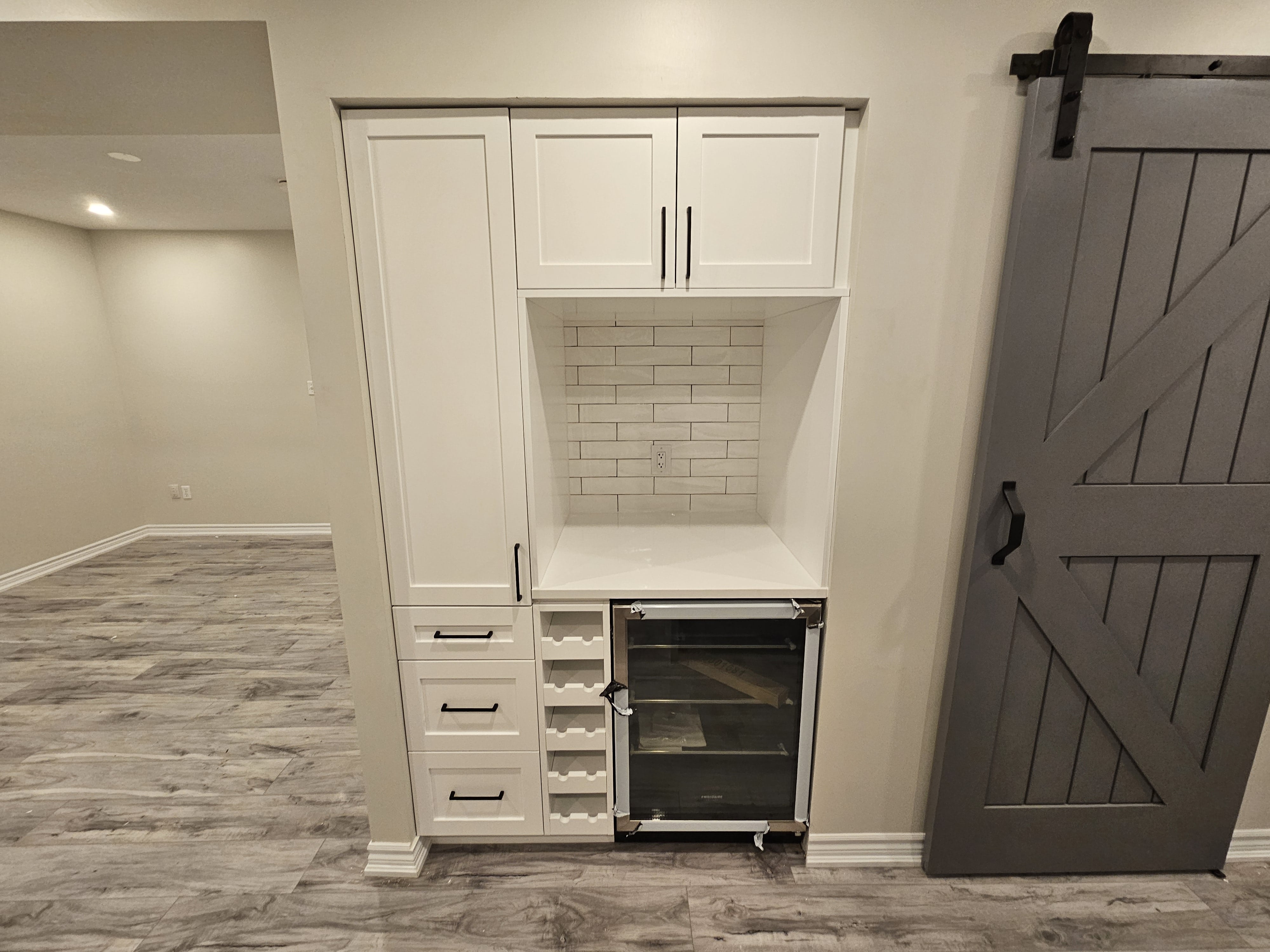 Custom cabinetry installation in a Cambridge, Ontario basement project by Goosen Inc.