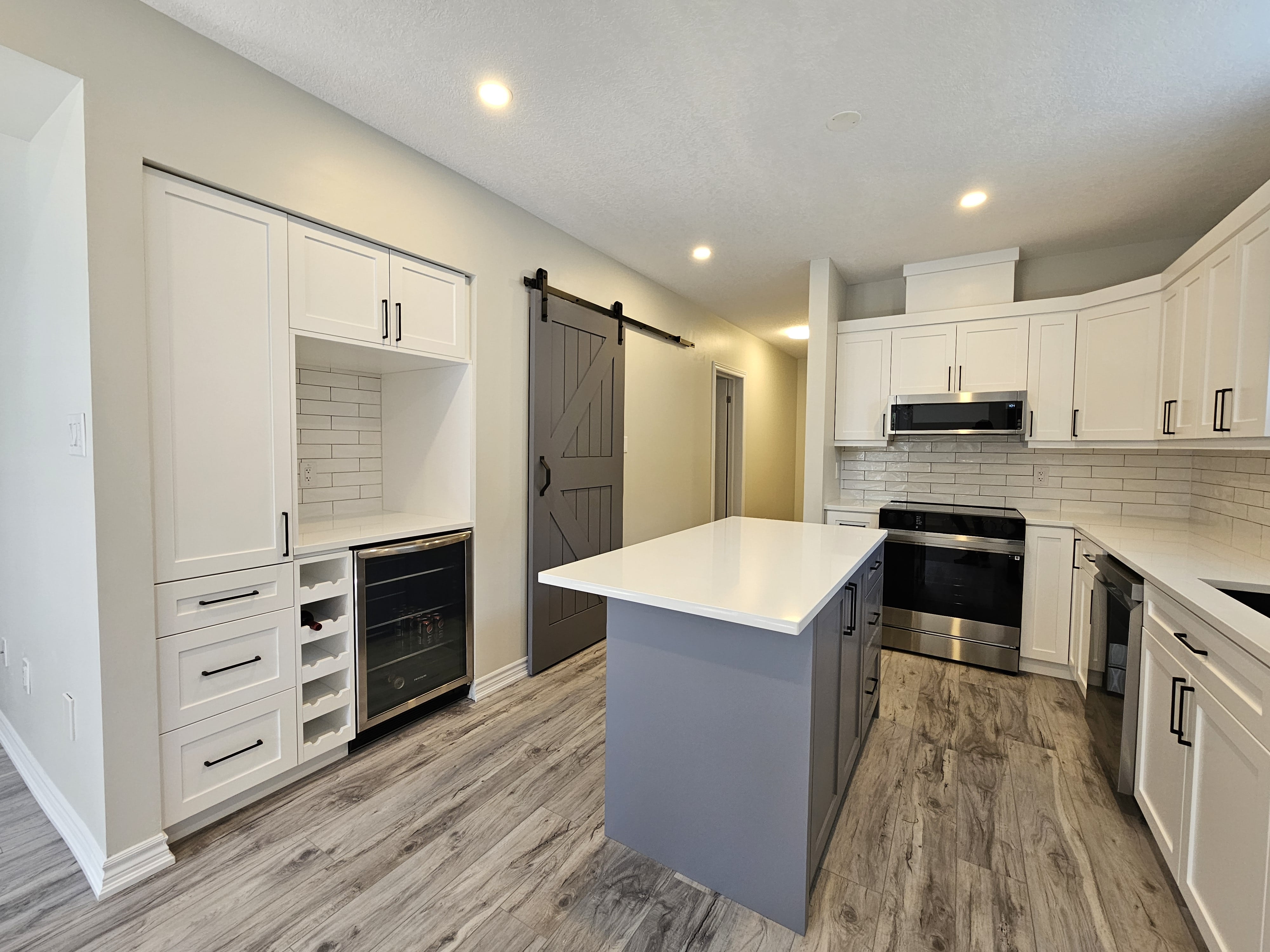 Custom kitchen island with cabinetry in a Cambridge, Ontario basement project by Goosen Inc.