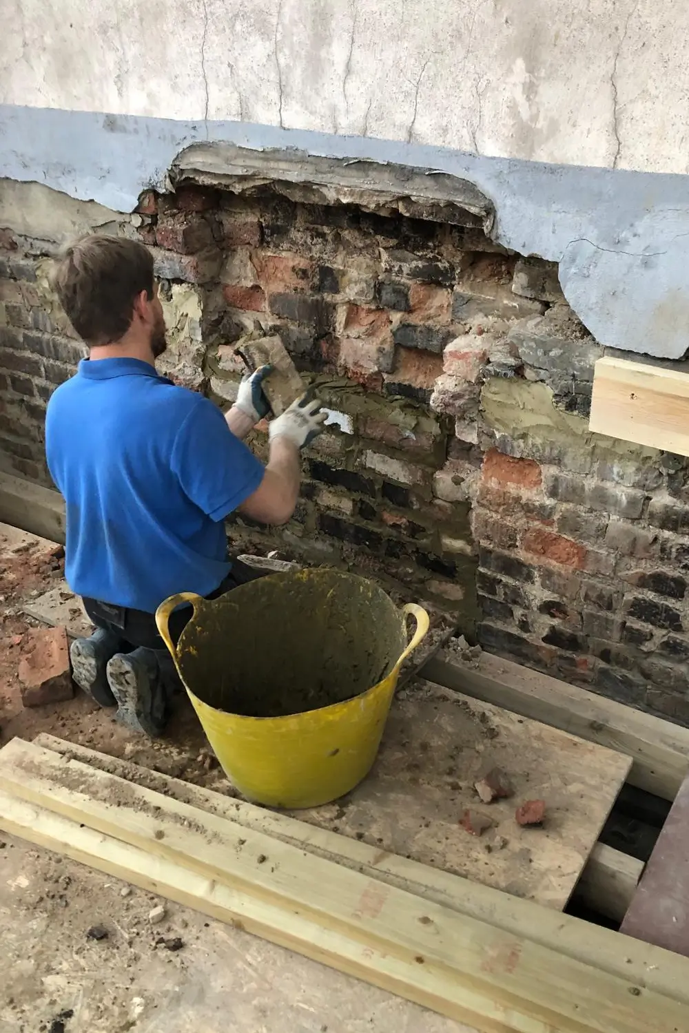 Party Wall Notice inside property builder fixing a wall