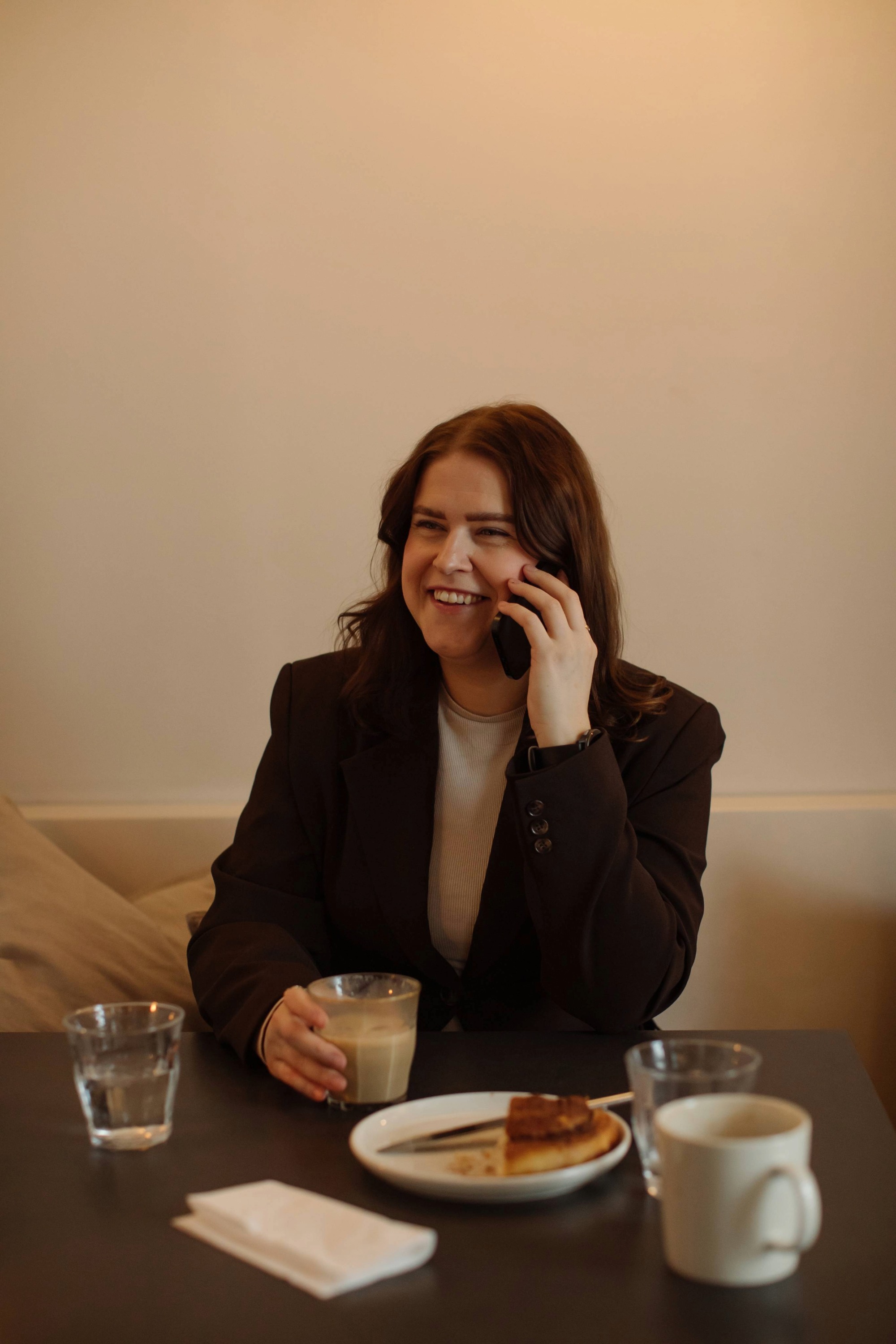 Therese Kristoffersen snakker i telefon på kafe. Grunnlegger av modn. 