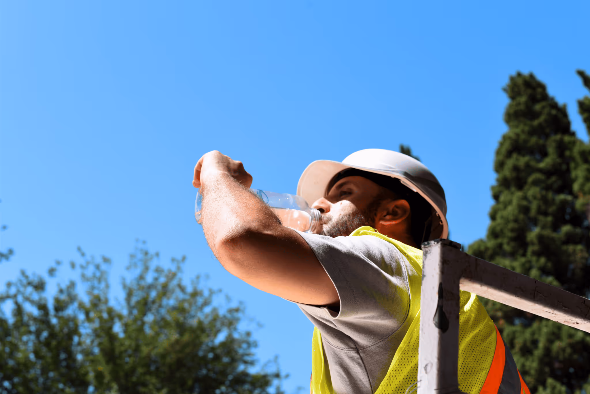 A construction worker drinking water from air on an off-grid site